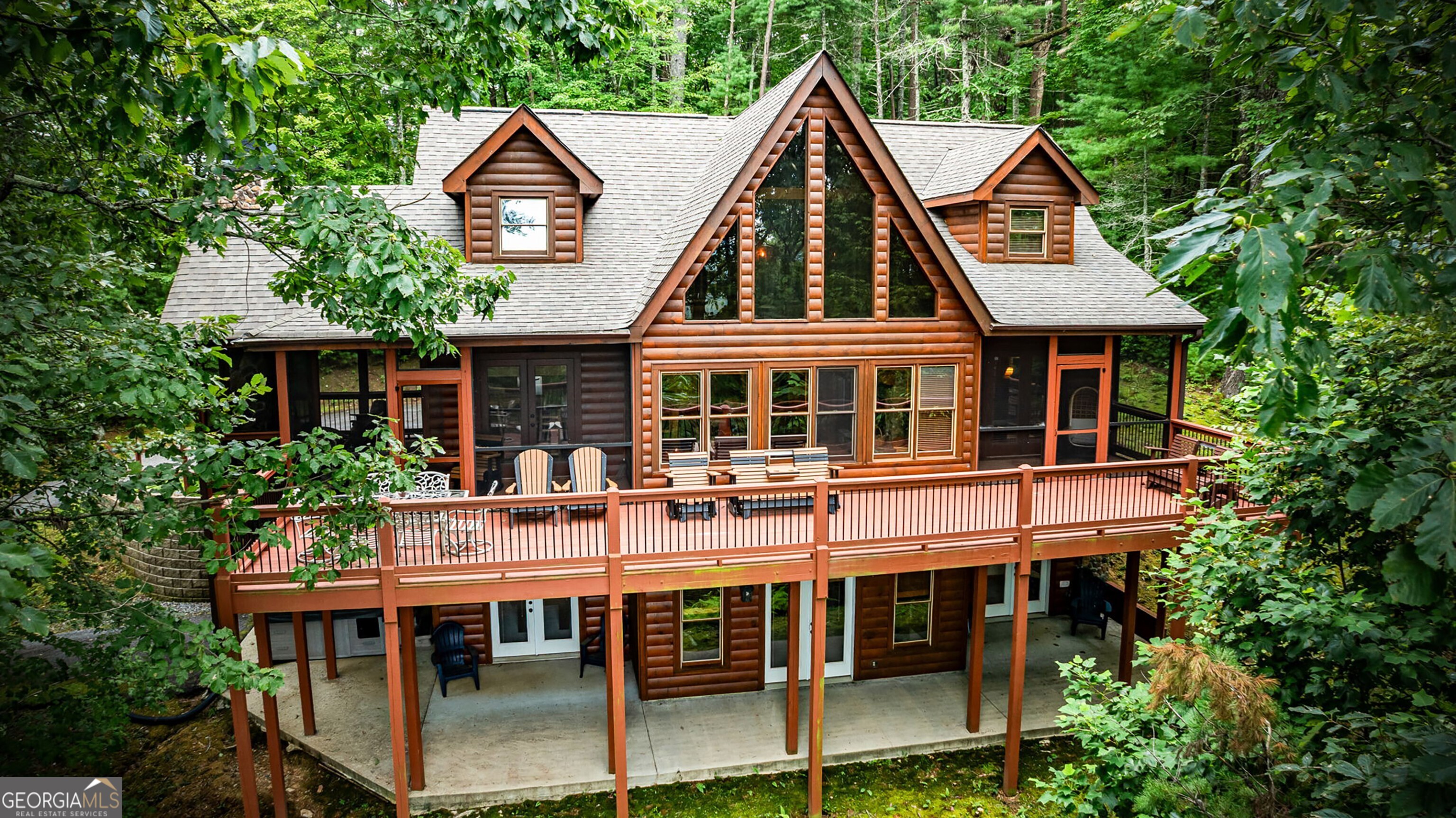 PRICE IMPROVEMENT!!! Charming Mountain Retreat Near Downtown Blue Ridge! Seller says MAKE AN OFFER! Nestled conveniently between Blue Ridge and Ellijay, Georgia, this stunning 3-bedroom, 3.5-bath cabin is the ultimate getaway for outdoor enthusiasts and those seeking a relaxing escape. Perfect for family gatherings or friendly getaways, this property blends comfort with adventure in the heart of the North Georgia mountains. From the moment you arrive, you'll be welcomed by the warm ambiance of three gas fireplaces, a striking floor-to-ceiling rock fireplace in the living room, a cozy hearth in the terrace-level family room, and a charming fireplace on the screened porch just off the kitchen. The open deck offers a patio dining area for al fresco meals, plus a gas grill for evening cookouts. The main floor features a serene Primary Bedroom with a king-sized bed and access to a second screened porch, creating a private retreat. Upstairs, you'll find a queen-bedroom and a loft with a daybed that converts to a king, while the terrace level hosts another queen-bedroom and spacious family room. Entertainment abounds with a pool table, foosball table, and a 6-person hot tub perfect for unwinding after a day exploring Lake Blue Ridge, the Toccoa River, or nearby hiking trails. Whether you're seeking a personal getaway, a vacation rental, or a full-time residence, this home offers a perfect blend of mountain charm and modern comfort. The seller is ready to entertain your offer, don't miss this chance to make this remarkable cabin yours!