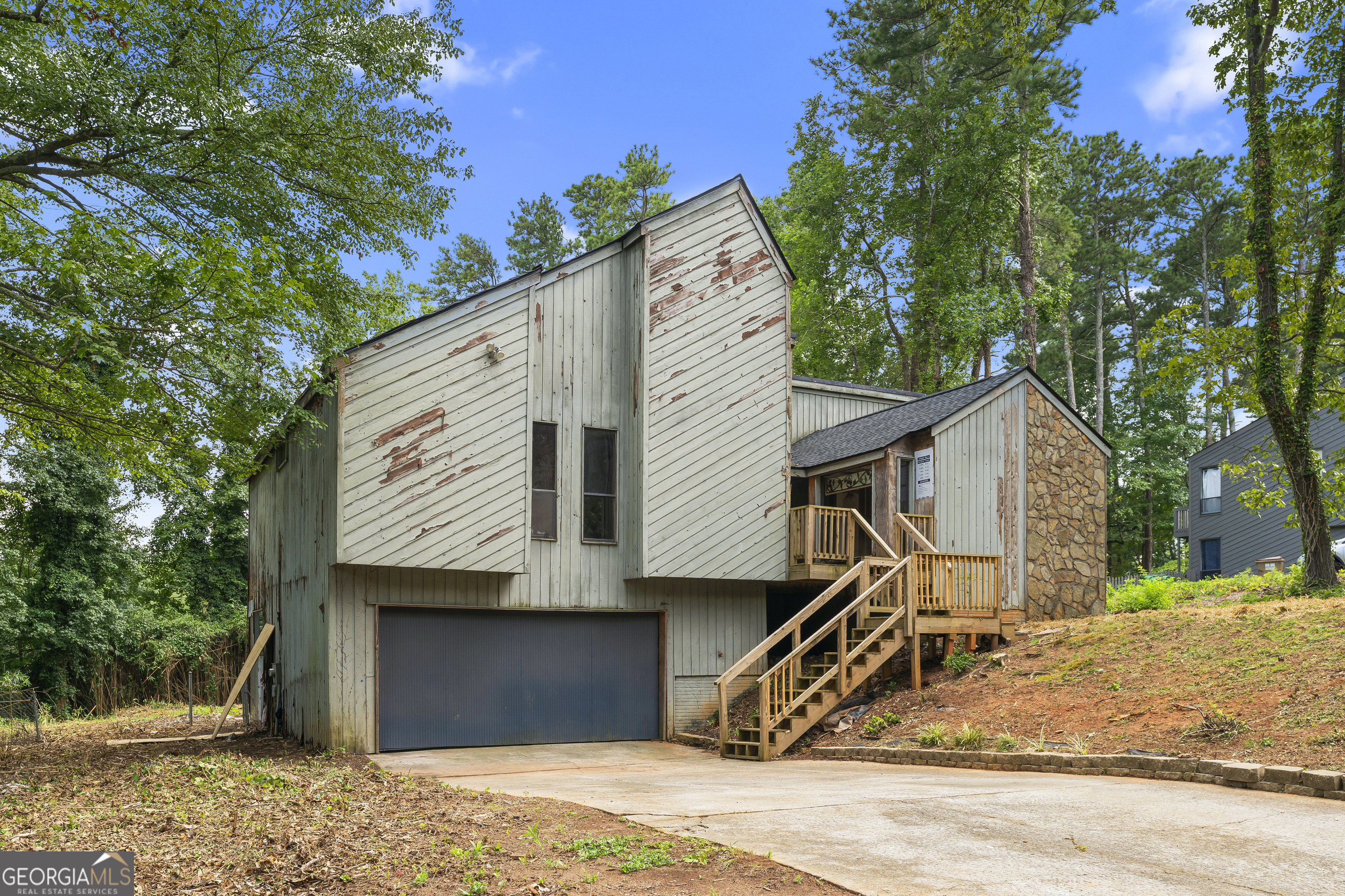 Fixer-upper opportunity in the Pope High School district. This contemporary 3-bed, 2-bath home, located in one of Metro Atlanta's top school districts, is a great option for an investor or homeowner willing to put in some work. The living area is spacious, and other features include a partial basement, garage, and a large backyard with a patio. Please note: the home is being sold as-is.