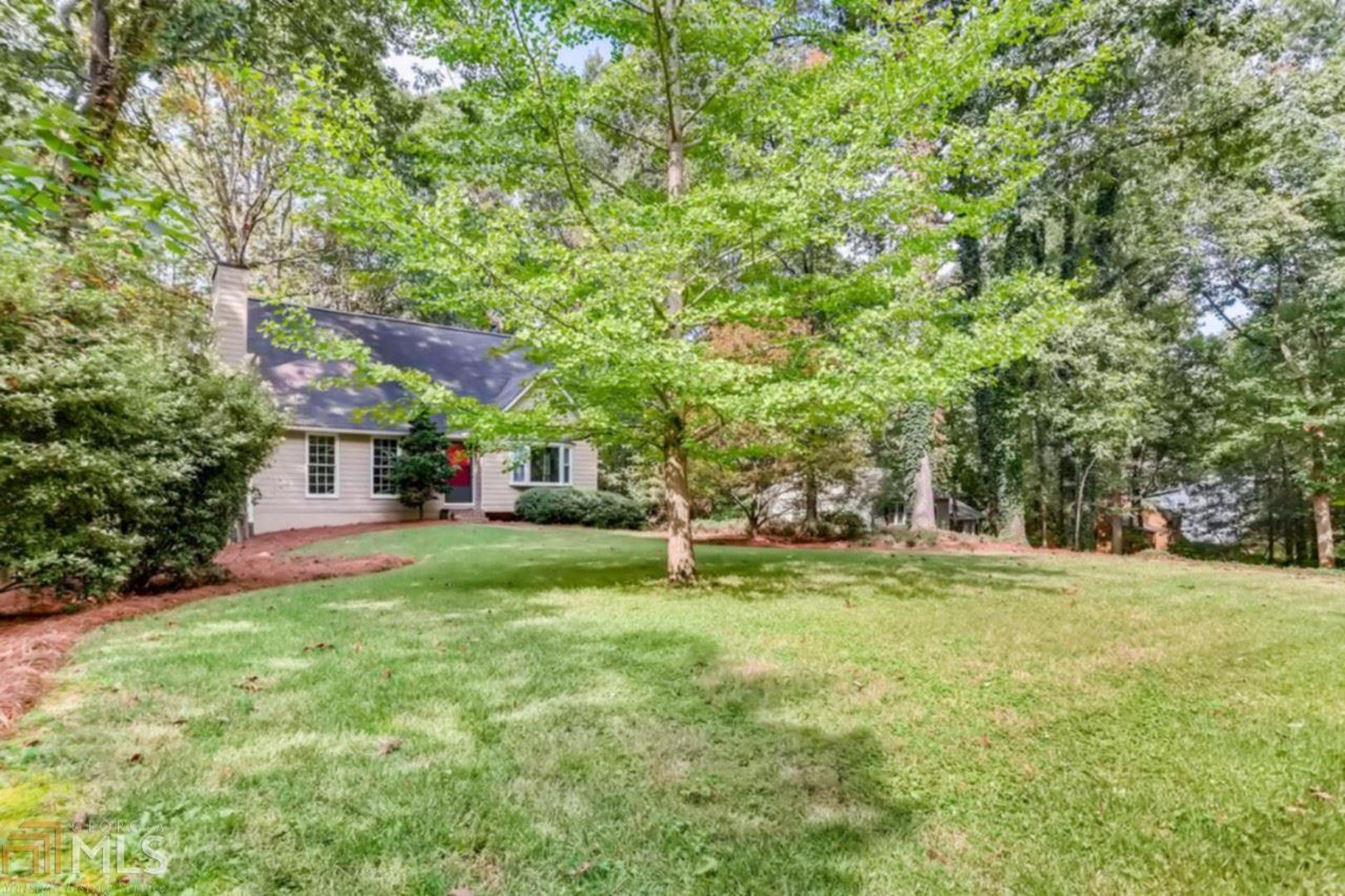 Resting on a large wooded lot, this charming home features a spacious owners suite on main, combination of new hardwood and carpeting throughout, gas fireplace & separate dining area ideal for entertaining. From the moment you arrive home you are greeted by soaring cathedral ceilings in the living room area paired perfectly with a full service kitchen that open to an enclosed balcony that can be the perfect setting for meals at home. Bonus features include 2 car side entry garage, unfinished basement space & access to the community pool. Located in the Cheatham Springs community you can walk to Kennesaw Mountain National Park & enjoy the convenience of nearby Historic Marietta Square, Smyrna, retail & entertainment destinations along w/accredited schools. Don't miss this opportunity to own your Cobb County dream home.
