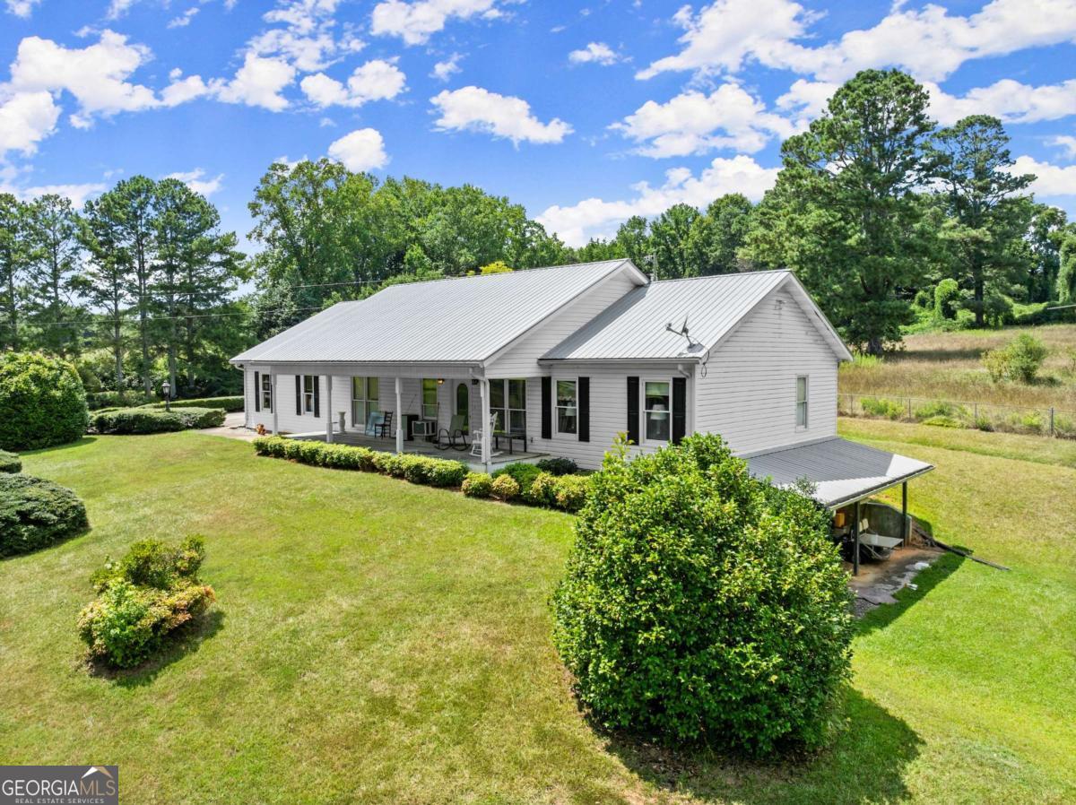 Incredible 35+/- Acre Opportunity in Forsyth County! A one-of-a-kind property offering space, functionality, and potential! This charming ranch-style home features 4 bedrooms and 3 full baths, including a fully finished basement with a second kitchen-perfect for extended living or rental possibilities. The main level offers approximately 1,600 sq ft, with an additional 1,400+/- sq ft in the basement. Enjoy peaceful mornings on the rocking chair front porch, or take in the beauty of two private ponds surrounded by rolling pastureland. The property includes a huge pole barn workshop with approximately 9 bays, ideal for storage, equipment, or hobbies. With over 1,400 feet of road frontage, City Water available, and mostly fenced pasture, this land is well-suited for horses, cattle, or future development. An additional home is located on the property and currently used as a rental, providing extra income potential or a spot for extended family. Conveniently located in growing North Forsyth County, this property offers the rare combination of usable land, privacy, and location. Don't miss this chance to own a legacy piece of property with endless possibilities! CUVA land conservation recently activated, with 9 years remaining out of a 10-year term.