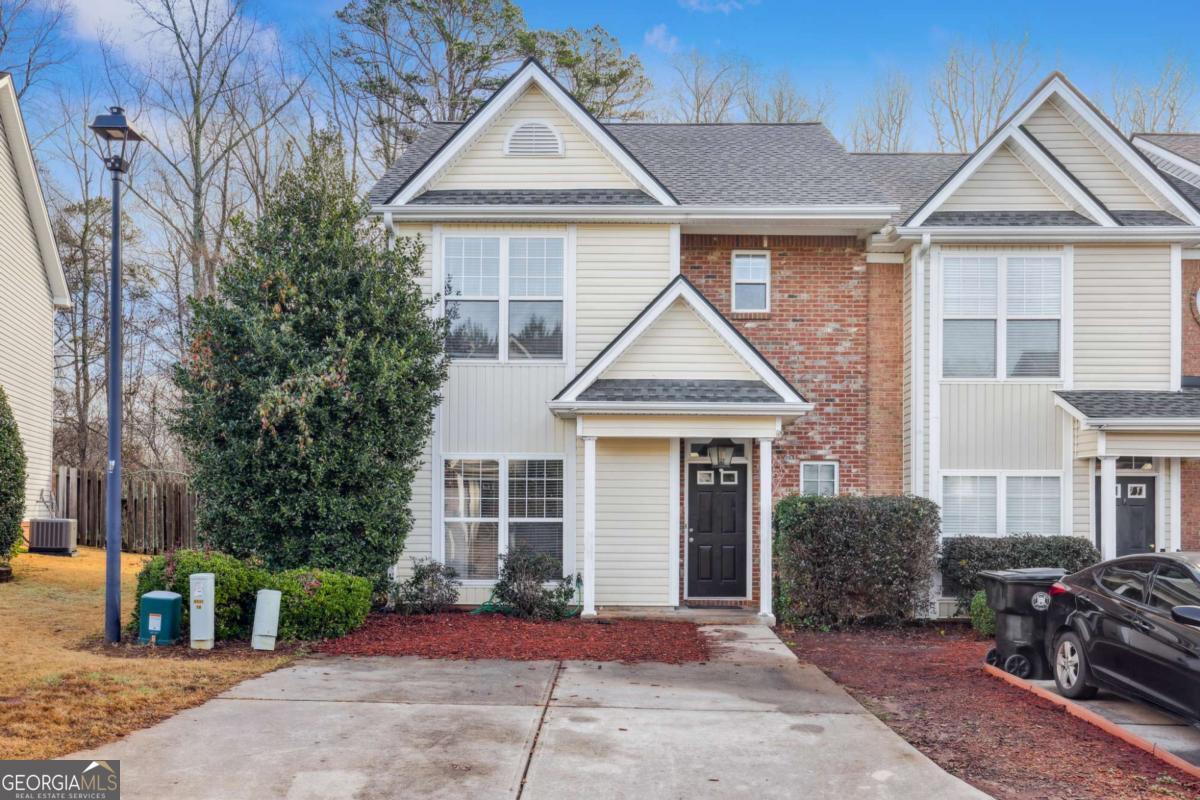 WELCOME TO THIS SPACIOUS AND LIGHT-FILLED END-UNIT TOWNHOME IN THE HEART OF DOWNTOWN DAWSONVILLE. Located in the well-maintained Maple Street Townhomes community, this 2-bedroom, 2.5-bathroom home offers the perfect blend of comfort, space, and convenience. Just minutes from local shops, restaurants, and parks, it provides easy access to everything Dawsonville has to offer. Step inside to find an open-concept living and dining area filled with natural light, featuring high ceilings, a cozy gas fireplace, and fresh updates including brand-new carpet and interior paint. The kitchen offers a practical layout with plenty of cabinet space, a breakfast bar, and easy flow into the main living space-ideal for both everyday life and entertaining. Upstairs, you'll find two generously sized primary suites, each with vaulted ceilings, walk-in closets, and private bathrooms. The laundry room is conveniently located on the upper level for added ease. Step out back to a fully fenced-in yard and private patio, perfect for relaxing, grilling, or creating your own garden retreat. This home includes a washer and dryer, is pet-friendly with a deposit, and is move-in ready. Located close to major highways, and within walking distance of downtown Dawsonville, this townhome is a fantastic rental opportunity in a prime location. Don't miss your chance to live in one of Dawsonville's most charming and convenient communities. Schedule your tour today.