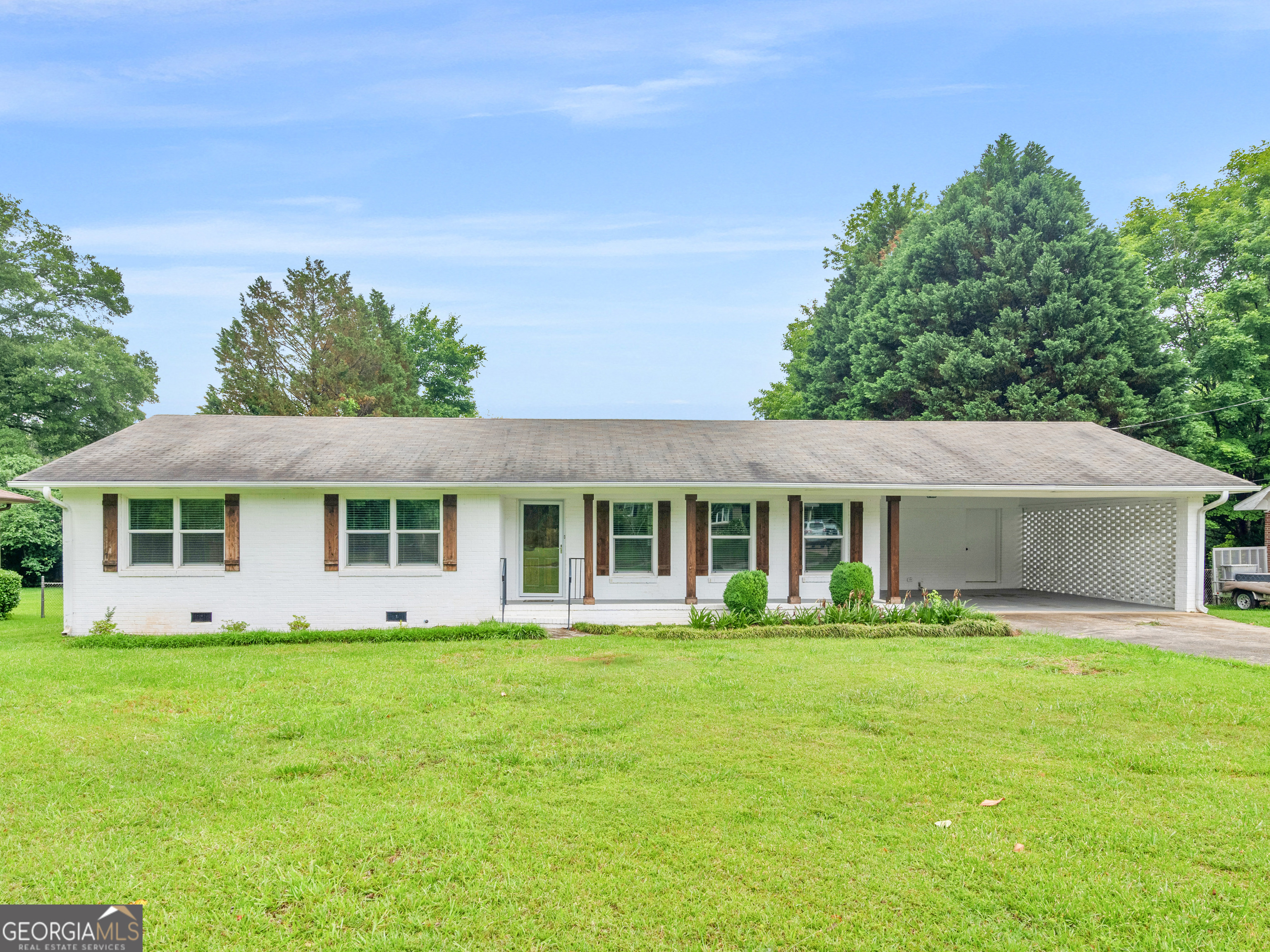 ALL BRICK RANCH in great location! This fabulous home is move in ready; The exterior offers updated painted brick with cedar columns and shutters along with spacious 2-car carport & storage closet. Expansive open family room/dining room area with huge brick fireplace is great for entertaining and with access to the vaulted screen porch overlooking your private backyard. The kitchen includes butcher block countertops, real wood cabinets, stainless steel appliances, separate pantry, and laundry room with cabinets and access to backyard area. The primary bedroom offers wide closet along with updated vanity, flooring, and large tiled shower in it's private bathroom; the secondary bedrooms are a nice size and there is a full bathroom off the hall with updated vanity and tiled tub/shower combo. You will enjoy the peaceful backyard with established trees, plants and shrubbery along with room to play and large outbuilding for additional storage. Located in desirable school district (Crescent) and just minutes from lake, shopping, Hwy 19/41!