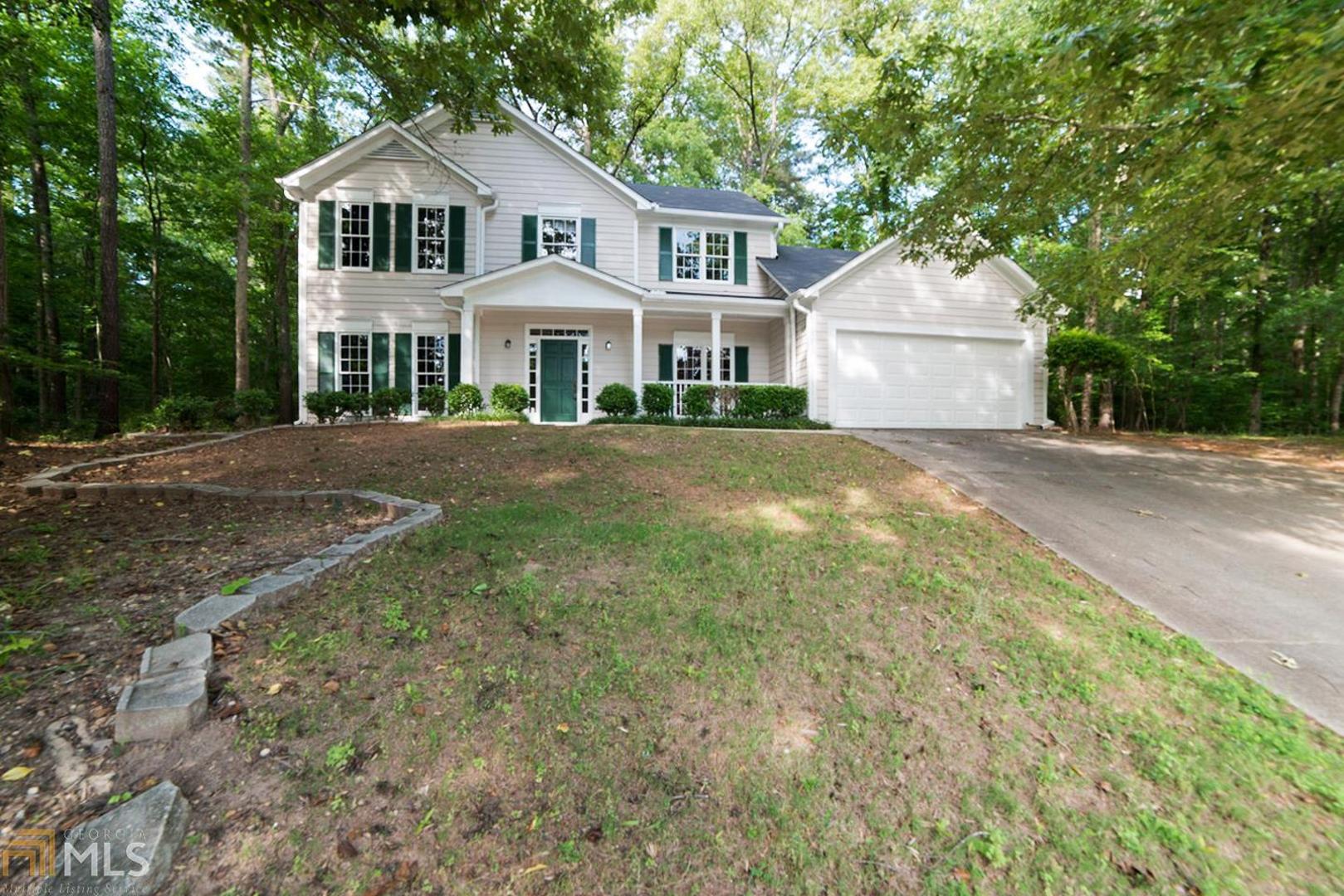 This Stone Mountain two-story offers hardwood flooring, a fireplace, and a two-car garage. Upgraded features include fresh interior and exterior paint, new vinyl flooring in select rooms, and a new range. Home comes with a 30-day buyback guarantee. Terms and conditions apply.