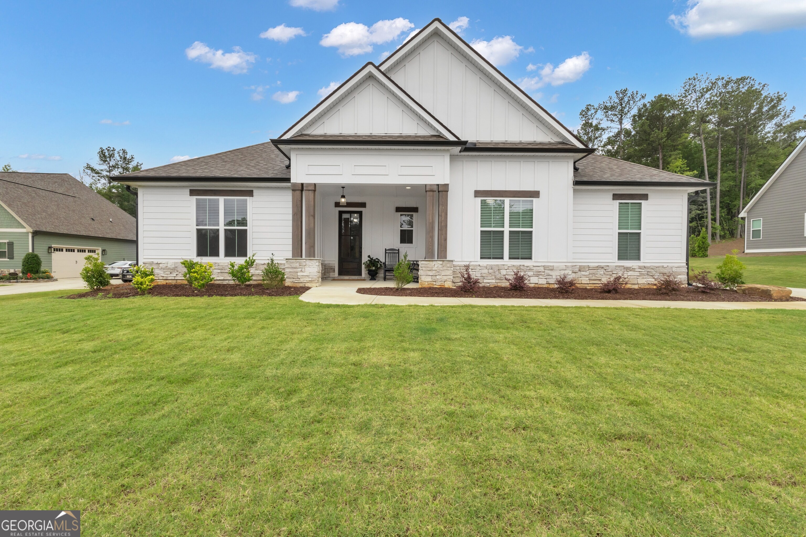 Nestled on a beautifully landscaped one-acre homesite in the prestigious Canoe Club community, this like-new ranch home offers elegance, functionality, and a lifestyle infused with nature and leisure. As you approach, the home's inviting curb appeal and classic craftsman charm immediately set the tone for the warm and welcoming atmosphere that awaits inside. Step through the covered front entry into a light-filled foyer, where hardwood floors stretch throughout the home, offering a seamless blend of sophistication and comfort-no carpet in sight. The heart of the home is an open-concept kitchen that will impress any culinary enthusiast. Designed with both beauty and purpose, it features a large center island with quartz countertops, a built-in wall oven and microwave, a 36" gas cooktop with a custom cabinet vent hood, and sleek stainless Frigidaire appliances. Rich wood cabinetry provides abundant storage, and the layout flows effortlessly into the family room, where a cozy fireplace and a raised hearth is framed by custom built-in base cabinets-perfect for displaying books or treasured keepsakes. Just off the foyer is a stylish powder room for guests and a thoughtfully designed mudroom entry from the two-car garage, complete with built-in cubbies and bench seating for everyday convenience. The home's smart layout includes three generously sized bedrooms and two-and-a-half baths. The owner's suite is a true retreat, boasting a spacious walk-in closet and a luxurious en suite bath with double vanities topped in quartz, a separate tile shower, and refined fixtures that elevate everyday living. Two additional bedrooms offer comfort and privacy for family or guests, with access to a beautifully appointed full bath. Step outside to the covered back porch, an ideal spot for morning coffee or evening unwinding, complete with a ceiling fan and peaceful views of the expansive, fully fenced backyard. The 2 car garage with additional space comes with a hookup for an EV charger. Whether you're hosting gatherings, playing with pets, or simply soaking in the quiet beauty of the surroundings, this outdoor space delivers serenity and possibility. Beyond the home, The Canoe Club community offers a lifestyle unlike any other. Spanning 600 acres and centered around two tranquil lakes-Menawa and Senoya-residents enjoy kayaking, canoeing, and fishing just steps from their door. The community clubhouse is a social hub, featuring a fitness center, catering kitchen, sunroom, and coffee bar, creating a warm and inviting space to connect. Additional amenities include a four-lane lap pool, lighted tennis courts, a lakeside wharf dock, and boat storage, offering something for every lifestyle and age. Perfectly positioned, the home is just minutes from Peachtree City's premier shopping and dining destinations, top-tier medical care at Piedmont Fayette Hospital, and the vibrant creative scene at Trilith Studios and Town at Trilith. Historic Downtown Fayetteville offers charm, boutiques, and a calendar of events, while convenient access to I-85 and Hartsfield-Jackson International Airport keeps you connected to the world. Families will appreciate the proximity to excellent schools, including Georgia Military College. And with the upcoming U.S. Soccer Federation Headquarters nearby, the future of this area is expanding.