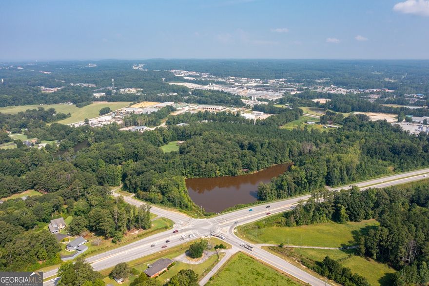 Exceptional development opportunity in Paulding County, strategically located just 30 minutes away from the airport and 30 minutes northwest of Atlanta. This prime parcel spans an impressive 85 plus acres and boasts the advantage of having water and electricity readily available on-site. Situated at the prominent intersection of Bill Carruth and Angham Road, this property offers unparalleled visibility and accessibility. Currently zoned residential, this versatile property presents a promising future for light to heavy industrial and commercial purposes. The area's future zoning plans align with the potential for light to heavy industrial and commercial development, making it an ideal investment for forward-thinking entrepreneurs and developers. One of the major highlights of this property is its proximity to Bill Carruth, a bypass road around Hiram Commercial District in Paulding County. This strategic location ensures a constant flow of traffic, increasing the visibility and exposure for any business ventures established here. The property further benefits from its adjacency to Norfolk Southern railroad lines, enhancing transportation and logistics options for industrial operations. Surrounding the property, you'll find a mix of industrial properties and businesses, creating a vibrant and dynamic environment. This blend of commercial and industrial enterprises fosters a thriving economic ecosystem, attracting a diverse range of consumers and potential customers. Don't miss this extraordinary opportunity to secure a sizeable 85 plus acre development site in Paulding County, offering easy access to Atlanta, vital utilities on-site, and the potential for future light or heavy industrial and commercial zoning. With its strategic location, excellent infrastructure, and proximity to key transportation routes, this property is poised to unlock unlimited possibilities for visionary investors and developers. Act now to secure your future in this rapidly growing and prosperous area. Purchase options: Parcel 1: $185,000 per acre. Parcel 2: $200,000 per acre. Parcel 3: $200,000 per acre.