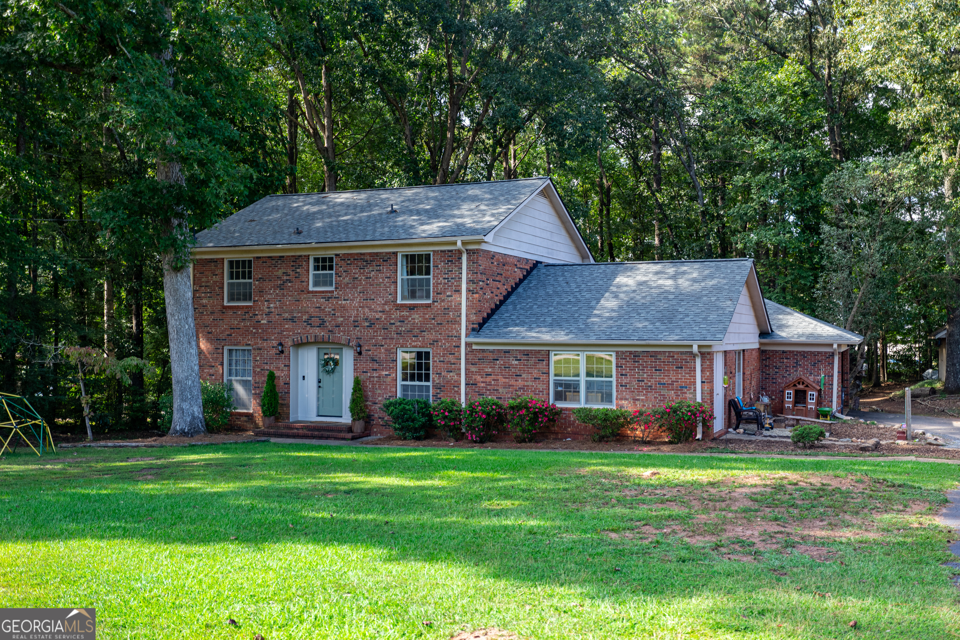Totally Renovated Brick Traditional in Sought-After Woodfield Community! Ideally located on the west side of LaGrange in the highly desirable, family-oriented Woodfield neighborhood-just minutes from the shores of West Point Lake and a short drive to downtown LaGrange, this stunning home checks all the boxes! Step inside to find a spacious, flowing floorplan thoughtfully designed for everyday living and entertaining. The beautifully updated gourmet kitchen features sleek quartz countertops, custom cabinetry, and a brand-new stainless steel appliance package. Wide-plank Life Proof flooring flows throughout, adding both style and durability. The oversized primary suite is a true retreat with a spa-like ensuite bath boasting a custom tile shower and luxurious finishes. Outside, enjoy a gigantic, screened porch overlooking the fenced, private backyard-perfect for gatherings or quiet evenings. Additional features include an updated roof, an oversized workshop with extra workspace, and a greenhouse for year-round gardening. This home offers the perfect blend of modern updates, timeless style, and an unbeatable location-an absolute must-see!
