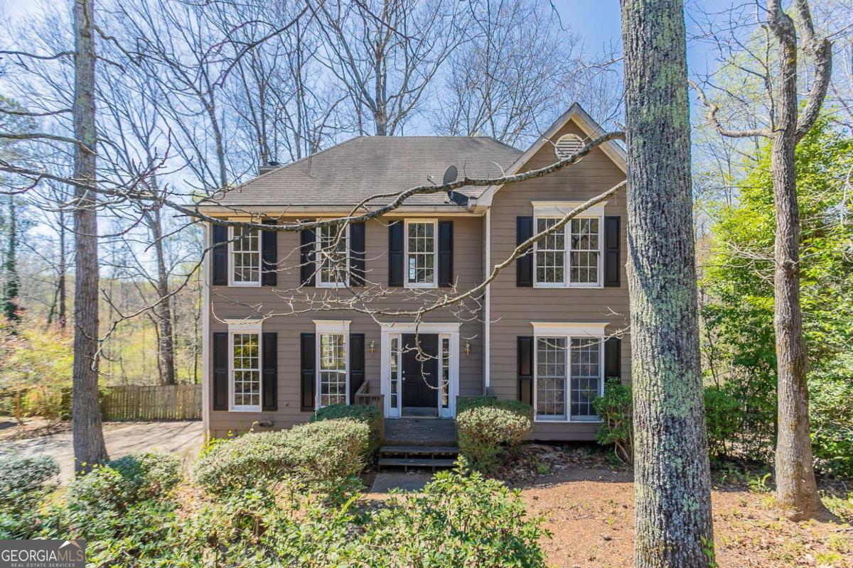 Beautiful curb appeal, an elongated driveway with a two-car garage. The inviting living room features carpeting, a fireplace, and a stunning bay window overlooking the forested backyard. The kitchen boasts stainles steel and black appliances, dark cabinetry, and an eat-in dining area with access to a deck perfect for outdoor relaxation. A powder room is conveniently located off the living room leading to the kitchen. Upstairs, the spacious primary suite offers a spacious closet, an ensuite with dual sinks, a soaking tub, and a separate standing shower. Two additional bedrooms share a full bathroom with a shower/tub combo. The lower level features a separate living space and entrance to the garage, providing flexibility for guests or additional entertainment space. The backyard is enclosed with a wooden fence, offering privacy and serenity. Don't miss this beautiful home! Book your tour today!