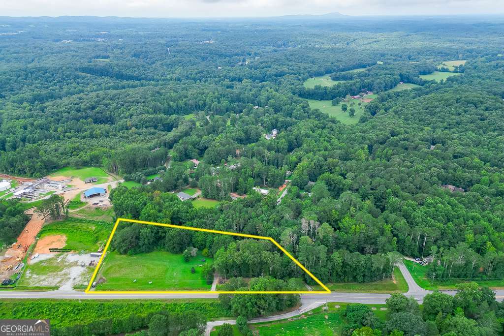 Prime 4 +/- Acres located on HWY 53, minutes from Downtown Dawsonville and HWY 400. This is a truly unique piece of property with High visibility, high traffic count and easy ingress and egress from both sides of the property. There is access to Water, High Speed Internet, Phone and Cable. With approximately 687 feet of road frontage, this location stands out for its central proximity to shopping, dining, and entertainment options. This versatile parcel is perfectly situated near major roadways and popular amenities, presenting endless possibilities. This property also features walnut trees, and various fruit trees sprinkled throughout the property. The creek at the rear of the property enhances its appeal, serving as a natural boundary and habitat for local flora and fauna. Deer, birds, and other wildlife are frequent visitors, making this acreage ideal for nature lovers and outdoor enthusiasts.