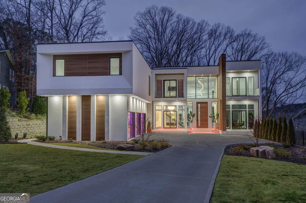 Don't miss this incredible opportunity to own a stunning, modern home on the tranquil Chattahoochee River. Boasting breathtaking views, this newly constructed, exquisite residence features large, floor-to-ceiling windows that showcase the river's beauty from nearly every room. The home's sleek, sophisticated design combines innovative craftsmanship with tasteful elegance-from the 15-foot pivoting front door to the impressive three-level floating staircase. The exterior of this one-of-a-kind property is adorned with Japanese Nichiha fiber cement siding, fire rock exterior steps, and all-Pella windows and sliding doors. The oversized three-car garage offers ample space, making this home both stylish and practical. The open-concept layout is perfect for modern living and entertaining, with a state-of-the-art security and entertainment system, plus a Cibes A-5000 air elevator with an EcoSilent drive system. Inside, you'll find Dayoris European soundproof interior doors, soft-close cabinets in the top-of-the-line kitchen, stone-topped countertops, and premium appliances, including a Sub-Zero climate-controlled wine refrigerator, extra-large Sub-Zero refrigerator with stack kits, Wolf double ovens, microwave drawer, and Sub-Zero/Cove dishwasher. All nine bathrooms feature Wi-Fi and humidity-controlled fogless mirrors, while the luxurious primary bath includes a multi-head, full-body shower. For ultimate relaxation, enjoy the home gym, followed by a session in the Wi-Fi-enabled Saunalogic dry sauna or the aromatherapy steam spa shower. The family room is anchored by a majestic, all-marble fireplace that reaches from floor to ceiling, perfect for cozy evenings watching the sunset over the river. With over 9,000 square feet of living space, a finished terrace level complete with a surround-sound home theater, three expansive balconies, and an infinity-edge pool with a hot tub, this home is an entertainer's dream. Ideally located just minutes from fine dining, upscale shopping, and with easy access to downtown Atlanta, this breathtaking, spacious residence has already been appraised, allowing you to benefit from its exceptional value!