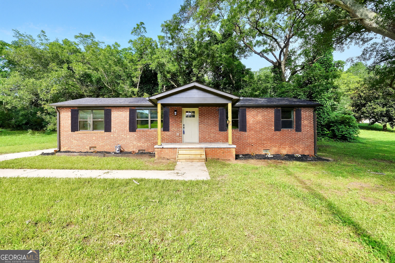 Fully Renovated Brick Beauty in the Heart of Barnesville! Welcome to 250 Mill Street-where everything is brand new from the floor joists to the roof! This stunning 4-sided brick home has been completely renovated with quality and style in mind. Step inside to find beautiful custom cabinetry, stylish tile showers, and a spacious split-bedroom floor plan offering privacy and functionality. You'll love the oversized utility room and ample storage throughout. Enjoy your mornings or unwind in the evenings on the covered back patio, all while being just minutes from downtown Barnesville and local amenities. Some listing photos have been virtually staged so you can get a feel for how this space could look fully furnished-just imagine the possibilities! *Shutters on the front are being installed, photo is a rendering of that* Whether you're looking for a move-in ready home or your next smart investment, this one checks all the boxes. Don't miss your chance to own this like-new gem-schedule your showing today! Listing agent is a licensed Realtor.