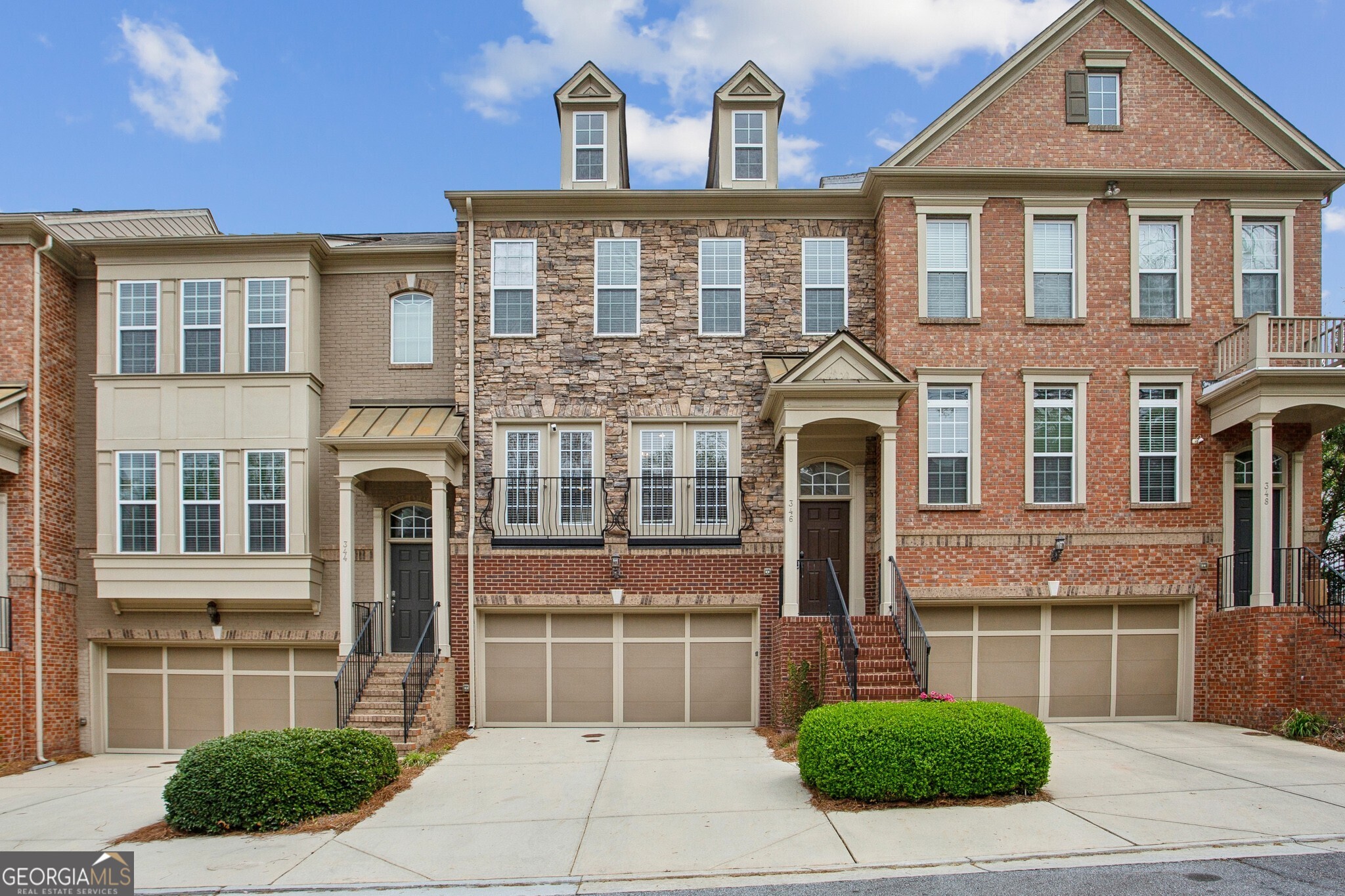 Stunning, light-drenched townhome within the desirable Ardmore Park community! This peaceful collection of sophisticated residences in Brookwood Heights at Ardmore offers effortless access to the vibrant hubs of Buckhead and Midtown, along with the recreational delights of Bobby Jones Golf Course and Bitsy Grant Tennis Center. Commuting is a breeze with I-85 and I-75 nearby, and you'll love being within strolling distance of Ardmore Park, the BeltLine, diverse shopping, and delicious dining. Step inside this open floor plan and move-in ready gem and discover meticulous details such as gleaming hardwood floors, a beautifully renovated kitchen and primary bath, striking moldings, and custom closet shelving. The welcoming foyer flows into a generous great room with a fireplace and an adjacent dining area, leading to a private deck perfect for entertaining. The kitchen is a chef's dream, boasting bespoke cabinetry, sleek quartzite countertops, a convenient center island with a breakfast bar, and stainless steel appliances including a gas range and microwave. French doors open to a delightful Juliet balcony. Retreat to the primary suite featuring a refined trey ceiling and a spa-like bath with separate vanities, a relaxing soaking tub accented by a lovely leaded glass window, a spacious shower, and a substantial walk-in closet. Two additional upstairs bedrooms share a well-appointed hall bath. The fully finished lower level provides a versatile bedroom, a full bathroom, and direct walk-out access to a patio and the courtyard. Complete with a two-car garage and an electric car charger, this is truly an exceptional place to call home!
