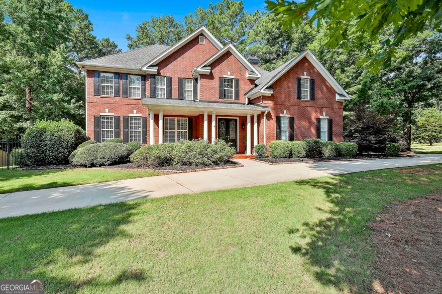 Welcome to this stunning all-brick estate home situated on a beautifully landscaped 1.3-acre corner lot in the Landings. With direct access to Peachtree City's golf cart paths, this 4-bedroom, 3.5-bathroom home offers a finished basement and saltwater pool. Inside, you're greeted by a dramatic two-story foyer. Off the foyer, a welcoming sitting room flows into the formal dining room, creating an elegant space for entertaining or relaxing. The gourmet kitchen is equipped with a 5-burner gas stove, double ovens, under-cabinet lighting, and updated fixtures.  The living room features a cozy fireplace framed by built-in bookcases and offers beautiful views overlooking the backyard. The spacious primary suite offers a fully updated bathroom that includes heated floors and a massive walk-through closet. Upstairs, you'll also find three additional bedrooms and a well-designed Jack and Jill bathroom. Head downstairs to the fully finished basement complete with a wine cellar, second kitchen, flex room and full bathroom. With laundry connections on both the main and upper levels, you'll have flexibility and ease in your daily routine. Enjoy the summer in your own private oasis, a newly renovated saltwater pool featuring a brand new liner, sand filter, lighting, and cleaning system. The fenced backyard also includes a sprinkler system and fresh landscaping. Located just minutes from both Peachtree City and Trilith, this home offers estate-style living in one of the area's most convenient locations. Don't miss your chance to make it yours! Southeast Mortgage is our preferred lender. If buyer chooses to work with them, Southeast Mortgage will provide 1% credit up to $5,000. Reach out to the listing agent for more information.