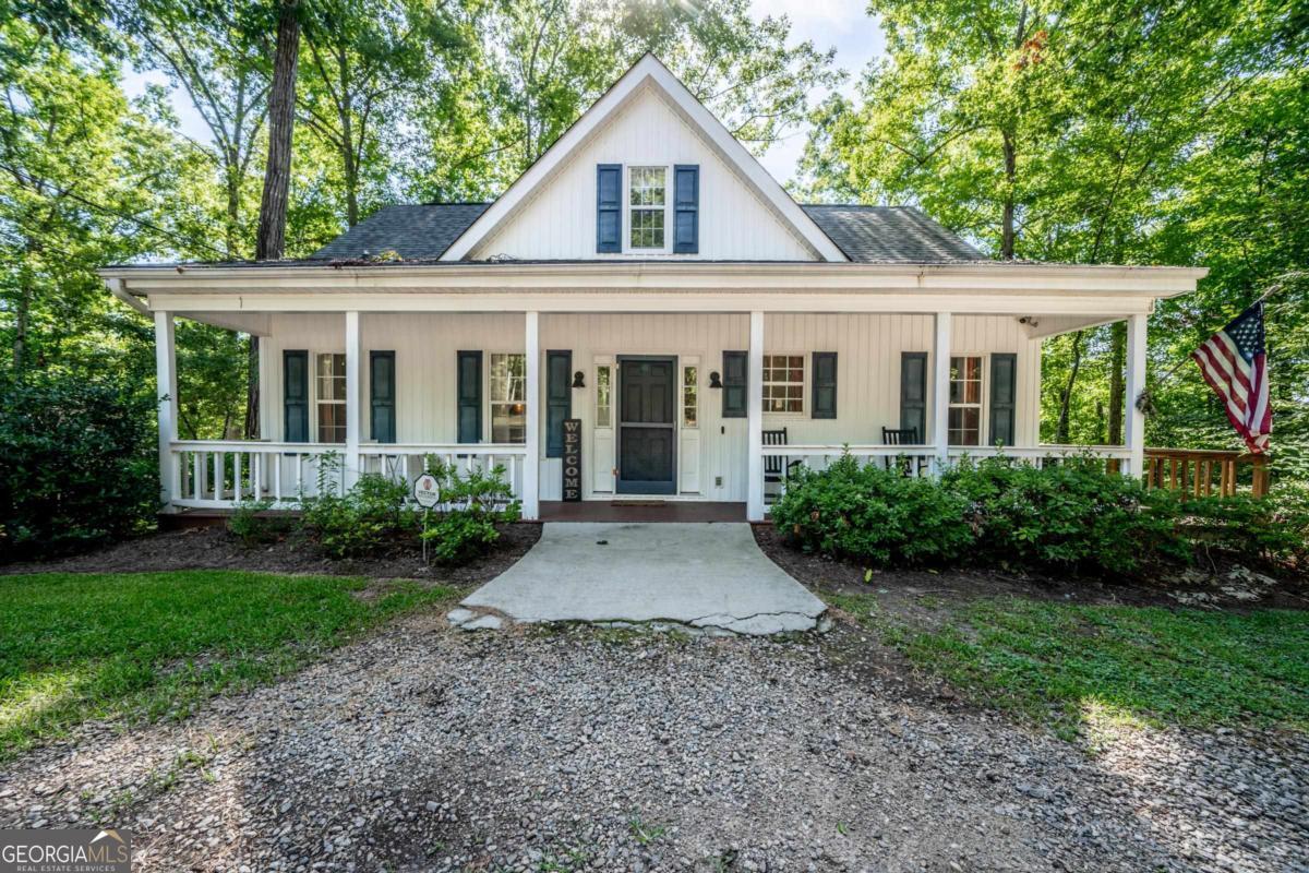 THIS LAKEFRONT COTTAGE ON LAKE SINCLAIR IS UPDATED AND ABSOLUTELY ADORABLE! THE IDYLLIC SETTING GREETS YOU WITH A LARGE COVERED FRONT PORCH AND STEPPLESS ENTRY INTO THE HOME. INSIDE, YOU WILL BE DELIGHTED WITH THE WELL-THOUGHT-OUT UPDATES THAT HAVE BEEN ADDED IN RECENT YEARS. THE LARGE FAMILY ROOM OPENS UP TO THE DECK WHICH IS GREAT FOR HOSTING THOSE LAKESIDE GATHERINGS. THE PRIMARY BEDROOM ON THE MAIN LEVEL AND TWO GUEST BEDROOMS UPSTAIRS PROVIDE THE PERFECT BALANCE OF SPACE AND PRIVACY. DOUBLE-STALL BOATHOUSE WITH BAR AND SPACIOUS STORAGE AREA COMPLIMENTS THIS LAKEFRONT LIVING. DEEP WATER (5-6 FT) AT THE DOCK AND THE CONVENIENCE OF THE COMMUNITY BOAT RAMP IS JUST AROUND THE CORNER. THIS LAKE CHARMER HAS BEEN AN AMAZING VACATION HOUSE AND AN INCREDIBLE INCOME-PRODUCING VRBO FOR THE LAST TWO YEARS! SELLER WILL GLADLY PROVIDE DETAILS TO WELL-QUALIFIED BUYERS. CALL US TODAY TO SEE THIS TRULY CHARMING 3 BED/2 BATH LAKE COTTAGE!