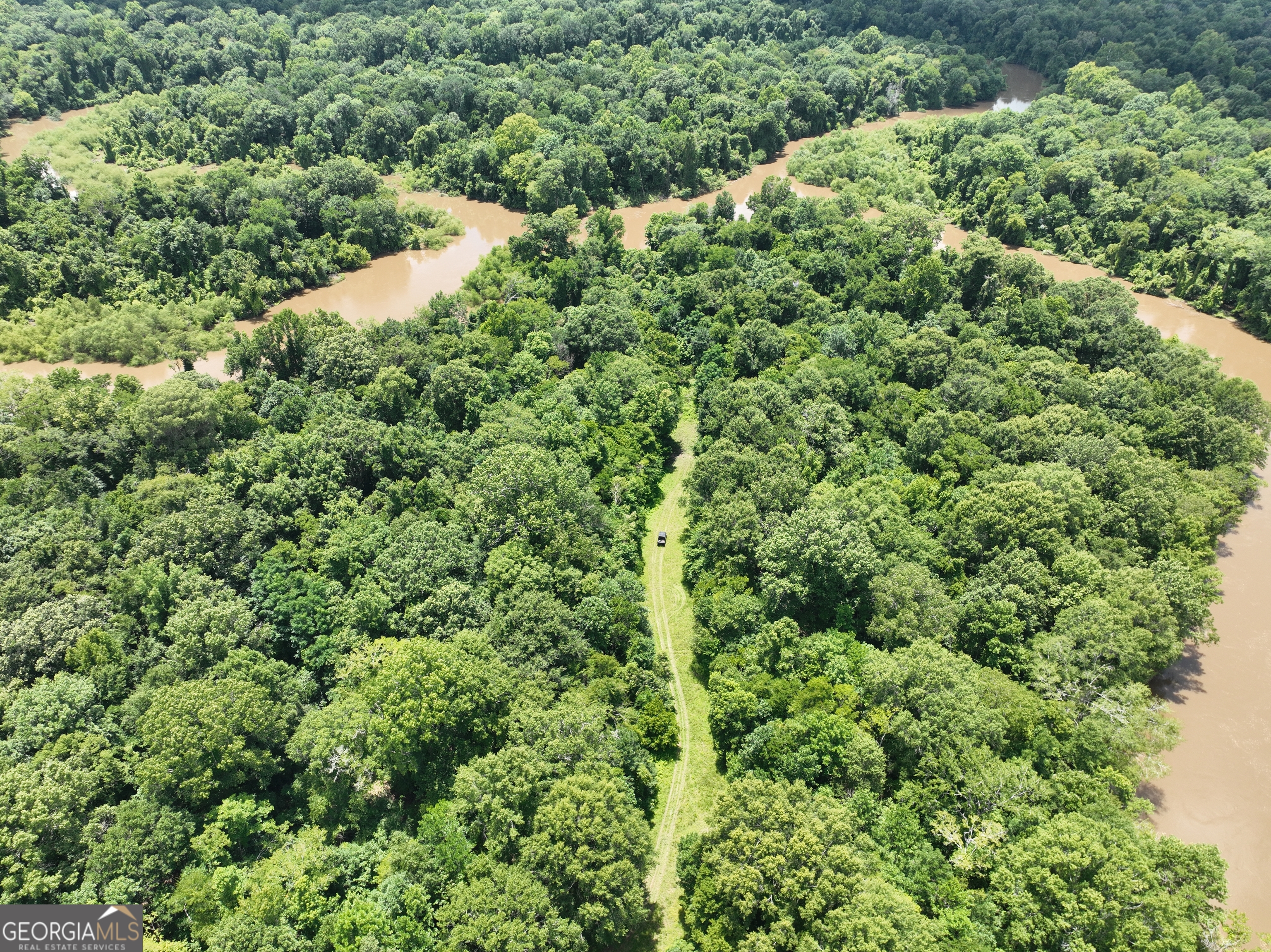 Nestled in the heart of Georgia, this breathtaking property along the Ocmulgee River offers an unparalleled chance to own a slice of Southern paradise. Whether you dream of a private retreat, a recreational haven, or a long-term investment, this gem offers endless opportunity. Conveniently located along GA Hwy 230, the gated driveway gives way to miles of well-maintained trails. The property has an outstanding balance between hardwood river bottom and upland planted pines, creating investment value that complements the abundant wild game. The stands of pines can provide generational cash flow, with ages ranging from a few years to over 30 years old. Turkeys, deer, ducks, and hogs provide year-round outdoor sporting opportunities, while fishing the river or hunting doves in the 20+/- acre dove field further adds to the recreational enjoyment. Several established food plot areas can be accessed through the excellent trail system, providing multiple entry points to hunting areas. The whitetail deer genetics in this area, when paired with the high-quality habitat of this property, are notorious for producing trophy bucks. A cozy cabin overlooks the dove field and is the perfect setup for a hunting retreat. A 2-bay shelter is attached to the cabin, conveniently offering a place to store equipment. Boasting significant frontage along the Ocmulgee River, this tract provides a waterfront setting for fishing, kayaking, or simply relaxing near the water's edge. The peaceful backdrop of the river is sure to create lasting memories with family and friends. Sand Hammock Boat Ramp is located just minutes from the property, providing quick and easy boat access to the river. An oxbow lake creates an island accessible from the river and is an excellent location for duck hunting. In all, the seclusion and serenity of this land can rarely be achieved in such a convenient location. The amenities of Hawkinsville or Eastman can each be reached with a 12+/- mile drive, providing access to grocery stores, restaurants, and schools. These key attributes combine to create one of the most unique recreational and investment opportunities on the market. Contact Grantson Martin for more information. A bank letter is required to schedule a showing of this property.