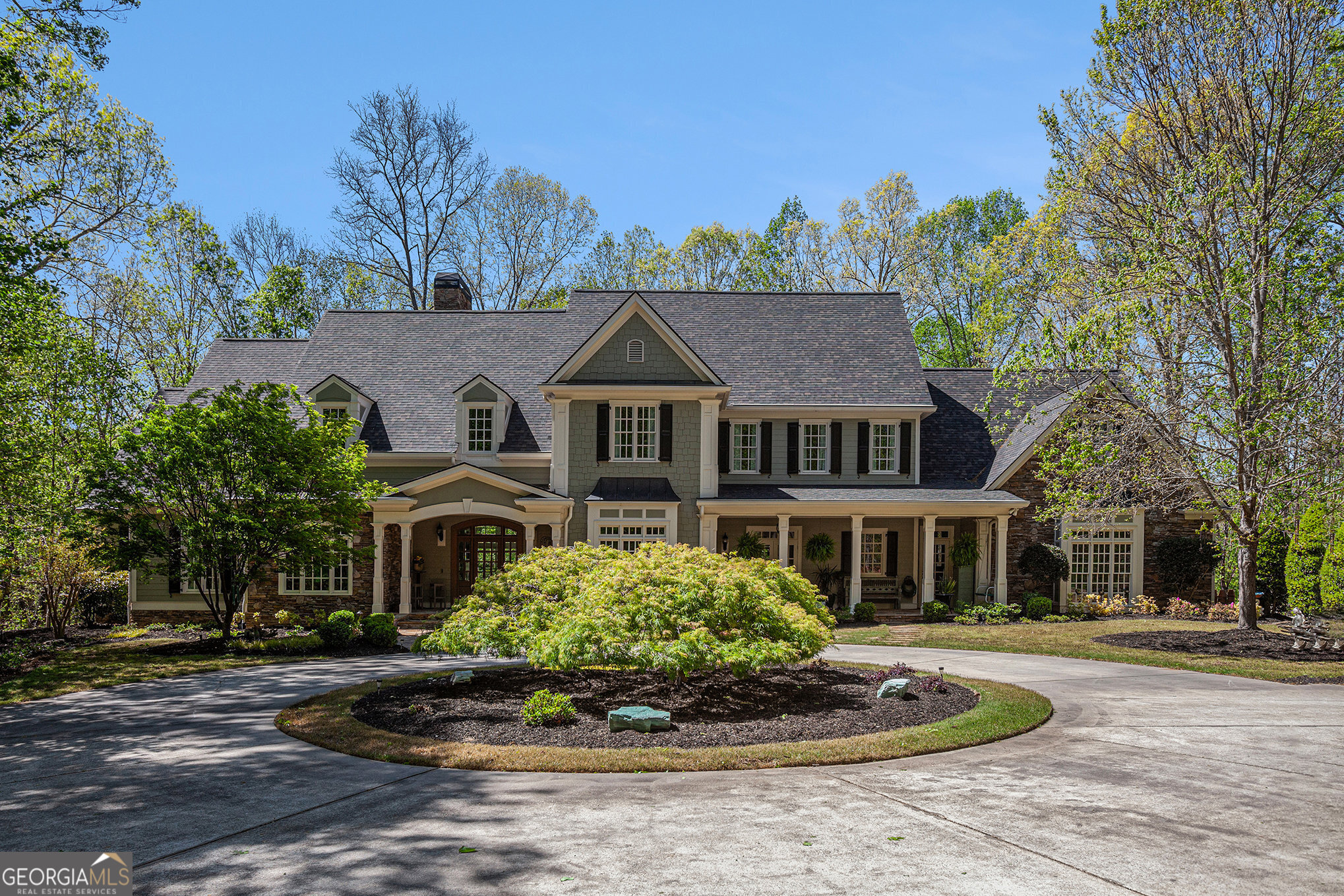 NOW is the time to make your dream home a reality! Welcome to your private luxury estate in the prestigious, gated community of The Summit in Dawsonville. Set on 6.72 gated and fenced acres, this remarkable residence seamlessly blends modern elegance with timeless charm. A long, tree-lined driveway leads you to a stately circular entry and a stunning home that offers both unmatched privacy and breathtaking curb appeal. Step onto the inviting front porch-perfect for morning coffee or evening relaxation-and into a home that feels brand new, thanks to a full-scale renovation with designer finishes throughout. Inside, rich hickory wood floors from Vermont, soaring ceilings, and exquisite architectural details reveal the owners? meticulous attention to quality and craftsmanship. At the heart of the home lies a dramatic two-story great room, where walls of windows flood the space with natural light and frame the home's warm, open design. The chef's kitchen is nothing short of extraordinary, featuring state-of-the-art stainless steel appliances-including an 8-burner professional range-custom cabinetry, elegant stone countertops, and an oversized island with seating. The kitchen flows seamlessly into the keeping room with its exposed beam ceiling and stone fireplace, offering the ideal space for both casual gatherings and cozy evenings. A custom-built bar nearby makes entertaining effortless. The primary suite on the main level is a private retreat, with ample space for a sitting area or reading nook. The spa-like bath invites you to unwind with its deep soaking tub, glass-enclosed steam shower, double vanities, and exquisite custom tilework, all bathed in soft ambient light. A walk-in closet with custom built-ins provides both beauty and function. Upstairs, generously sized secondary bedrooms each feature a private full bath and walk-in closet, ensuring ultimate comfort for family or guests. A spacious bonus room above the oversized 3-car garage offers endless flexibility-a playroom, office, gym, media space, or even a 7th bedroom. The fully finished walk-out basement adds an entirely new level of luxury, with a game room, custom home theater (complete with 7.1 surround sound and 4K projector), stone fireplace, a second bar with dual ice makers, and a large guest suite with full bath. Spray foam insulation, 10-foot ceilings, and careful design make this lower level both efficient and inviting year-round. Additional highlights include: Central vac system 3 fireplaces 5 AC units Sunroom & Trex deck for year-round enjoyment Professional landscaping with irrigation system Outdoors, the beauty of North Georgia surrounds you. This expansive acreage offers endless possibilities-room for a pool, gardens, or even a mini vineyard. The property is frequented by deer and native wildlife, offering a true sense of peace and retreat. Fully fenced and surrounded by protected land, your privacy will remain preserved for years to come. Despite its serene setting, the location is unbeatable-just minutes from Lake Lanier, North Georgia Premium Outlets, scenic parks, wineries, and the Blue Ridge Mountains. This home offers the rare balance of tranquility and convenience. This is more than just a house-it's an extraordinary lifestyle. An unparalleled opportunity to own a one-of-a-kind estate where distinctive design meets natural beauty.