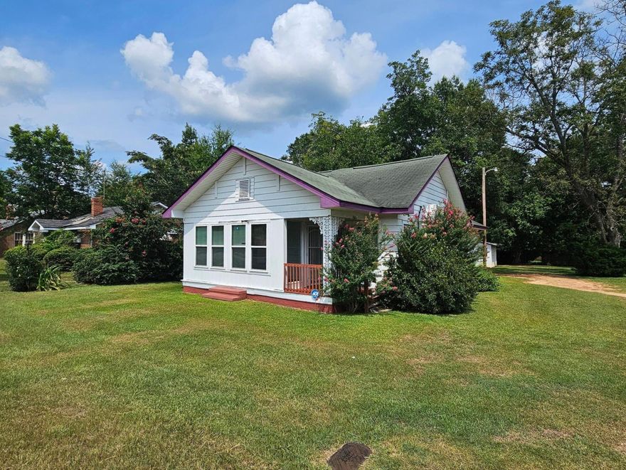This extremely cute cottage is situated on a half-acre lot in the heart of the quaint town of Louisville. This home is within walking distance to the elementary school and the local park. With a little love, this could make a beautiful home! The original hardwoods are throughout, with the exception of the kitchen and bathroom. There were 3 fireplaces, two of which have been sealed off. The front of the house boasts a relaxing sunroom, that leads into the living room. At the back of the property, you will find a double carport and covered deck that leads in the enclosed porch/laundry area off the kitchen. This property could easily be transformed with a little love!