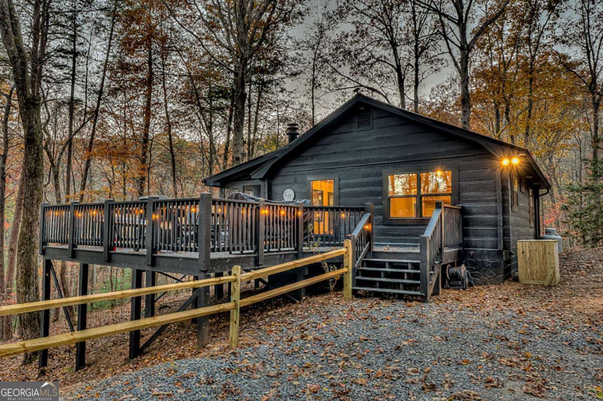 Nestled in Cherry Log's mountain community, Treetop Getaway is a recently renovated log-style cabin that harmoniously blends historic charm with contemporary rustic and chic design. Despite its central location, the cabin exudes a secluded ambiance, inviting guests to unwind in the serenity of nature. Inside, the amalgamation of old and new is evident as modern rustic accents seamlessly interweave with classic log-style architecture. Cozy living spaces adorned with plush furnishings and a crackling fireplace beckon guests to leisure. The well-designed kitchen is a culinary haven against the mountain backdrop. The bedrooms, adorned with comfortable linens and charming decor, ensure a restful night's sleep. Outside, a spacious deck perfect to relish the crisp mountain air, whether sipping morning coffee or stargazing in the tranquil evenings. Treetop Getaway invites you to experience the enchantment of Cherry Log Mountain in comfort and style.