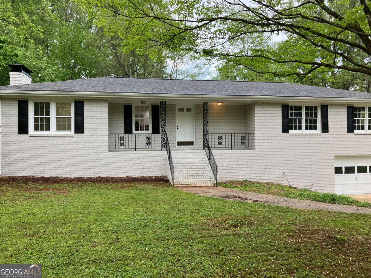 Charming 4-sided brick ranch in the coveted Sandy Plains Estate neighborhood! This bright, open concept home is equipped with updates throughout including new roof, new flooring, new plumbing, freshly painted inside and out, updated kitchen and bathrooms with an extra large master bath, and updated electrical and lighting. Recently updated with luxurious granite countertops that exude sophistication, the kitchen boasts a spacious island, perfect for both meal preparation and casual dining. Gleaming stainless steel appliances add a touch of contemporary style. Get comfy in the big family room with a cozy fireplace. The large screened-in porch overlooks a fenced, level backyard that can be your private sanctuary or place for entertaining friends and family. This home also has a full daylight basement, partially finished, for added space to customize and personalize as you choose. Located just minutes from I-75, I-575, Marietta Square, shopping, and fantastic local dining options, this home is also situated in the highly regarded Sprayberry High School district. No HOA! Don't miss this gem in the heart of East Cobb.