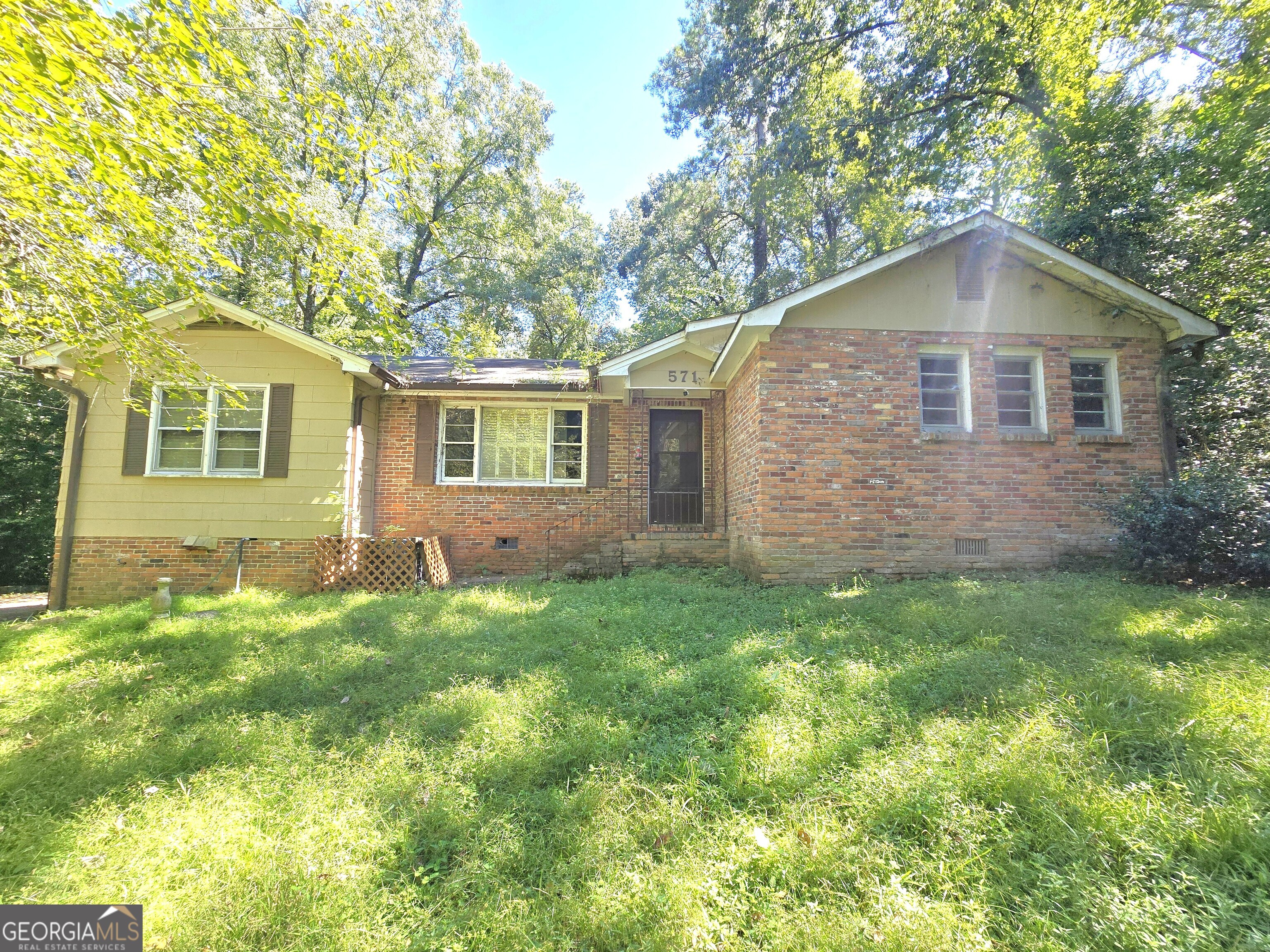 Fix & flip Opportunity or move in with Equity! Nestled down a long, winding, wooded driveway, this home offers seclusion, peace, and privacy right in the heart of North Macon. Needs work but awesome potential! The home provides a great layout with a huge kitchen open to a great room with brick fireplace, separate dining, and living room w/ hardwood flooring. 2 Br / 2 Br on the main, both w/ walk-in closets, and both bathrooms recently remodeled. 3rd bedroom and 3rd bathroom in the basement along with a huge workshop area with walk-out access to the covered rear porch. Plenty of parking. Sold As-Is. Must sign Hold Harmless Agreement prior to entering. Priced to move quickly!!