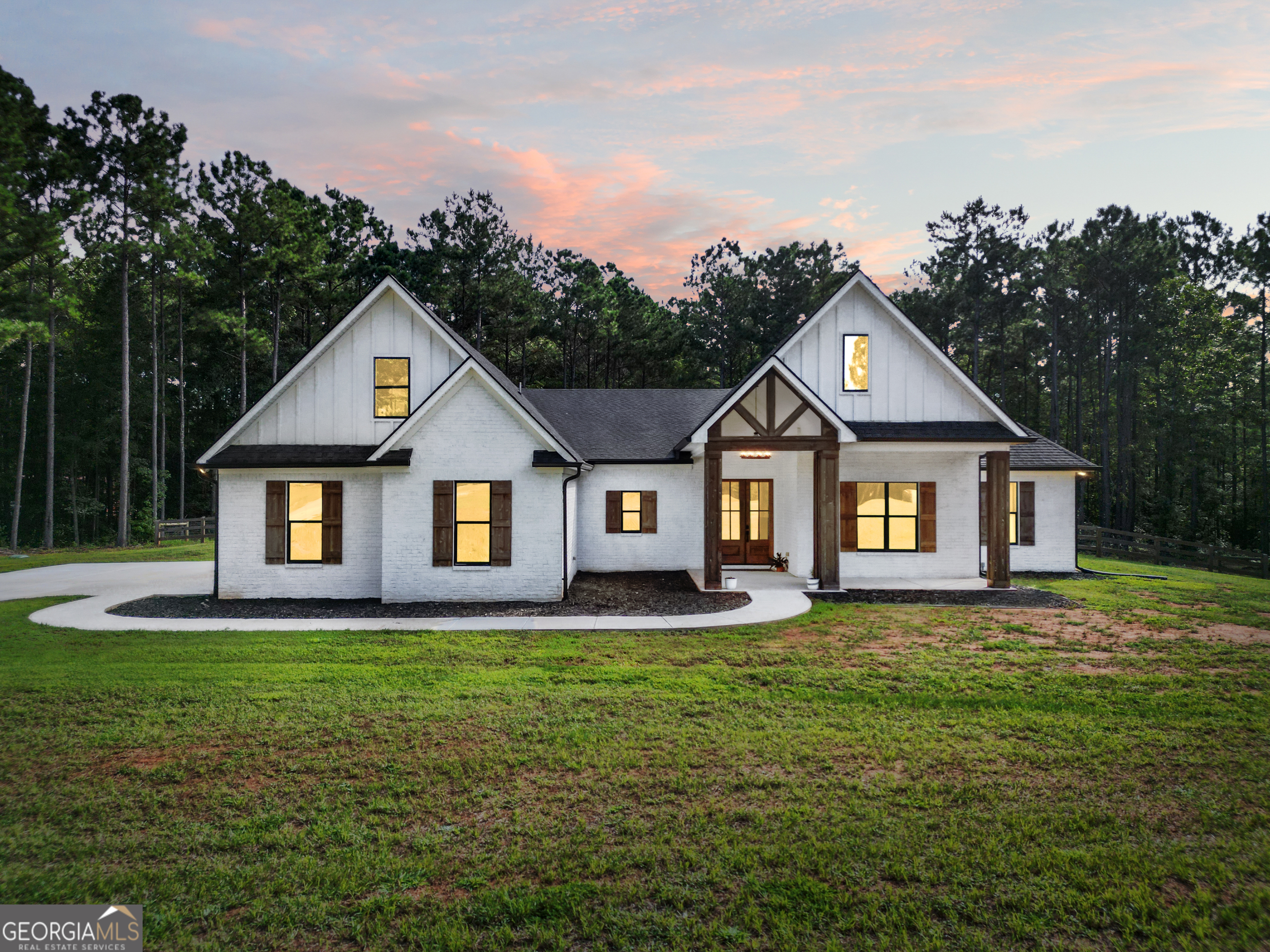 Experience the best of country living in this custom-built 2 year young home on over 12 private acres in Lamar County. From the moment you arrive at the gated entry, you'll appreciate the sense of seclusion and craftsmanship throughout this property. Inside, the living room impresses with vaulted ceilings accented by wood beams, while the trey ceiling in the master suite adds elegance and dimension. The home features 3 bedrooms, 2.5 baths on the main level, plus a full bedroom and bathroom upstairs for guests or extended family. A versatile flex room makes the perfect office or playroom, and custom shelving and spray foam insulation enhance both style and efficiency. The heart of the home features a cozy fireplace, a gas range with a large vent hood, a pot filler, and this home has an efficient tankless water heater. The master bathroom is finished in tile, showcasing craftsmanship and durability. A large laundry room with a doggy wash station adds practicality and convenience for modern living. Step outside to enjoy massive front and back porches - perfect for sipping hot coffee on crisp fall mornings - while the fenced backyard provides a secure space for pets or play. Cedar columns add rustic charm to the exterior, and the 3-car garage offers ample parking and storage. This property combines modern efficiency, luxury finishes, and timeless character with all the privacy and acreage you've been dreaming of.