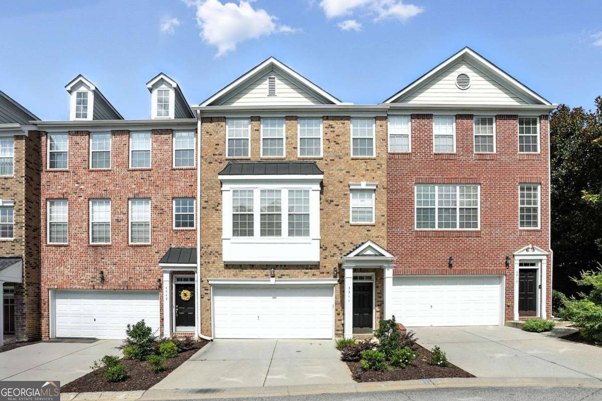 Don't miss this beautifully updated townhome in a gated community with a 2-car garage and all the space you've been looking for! Step inside to find a bright and stylish kitchen with white cabinets, granite countertops, sleek slate appliances, a breakfast bar, and a sunny spot to eat, all open to the large living room with a cozy fireplace. You'll love the brand-new hardwood floors on the main level and the fresh paint throughout. Upstairs, there are two amazing primary suites both with totally updated bathrooms featuring double vanities, walk-in showers, a new tub, and big walk-in closets. There's also brand-new carpet in all the bedrooms and an updated laundry room with new flooring and cabinets. Need more space? Head downstairs to the finished basement with two more bedrooms, all new carpet, a fully renovated bathroom, and a walk-out patio perfect for guests, a home a home office, or whatever fits your life. Chattahoochee Bluffs has it all, pool, clubhouse, walking trails that lead right to the Chattahoochee River National Park, and it's super close to The Battery and Truist Park. Plus, you get top-rated East Cobb schools, low Cobb County taxes, and quick access to I-75 and I-285. Updated top to bottom, Room for everyone, Prime location This one really has it all! Come see it before it's gone!
