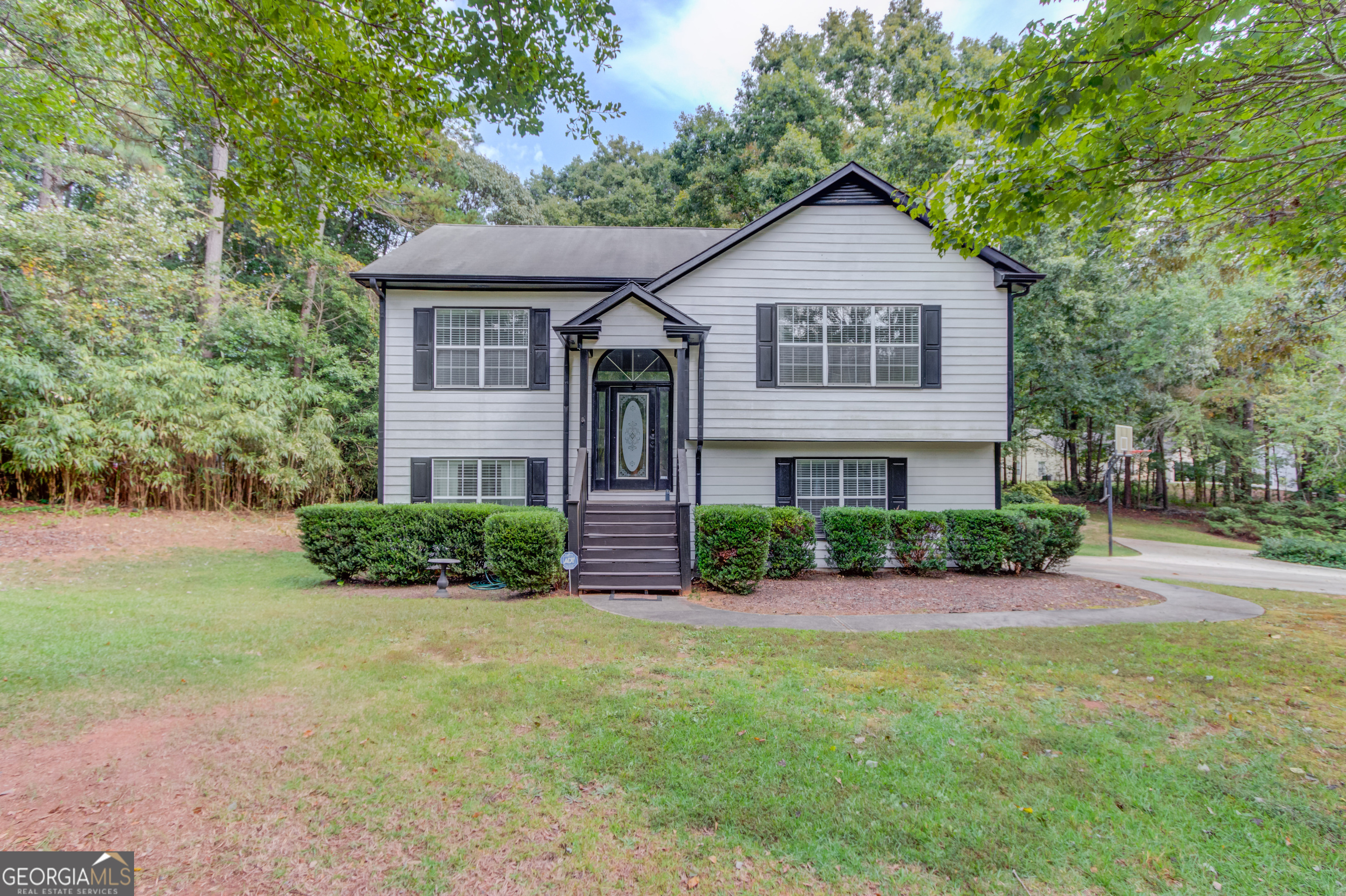 Beautiful 3 bed, 2.5 bath home on a corner lot in Winder's Cedar Ridge community located in the Winder-Barrow High School District. This split-level home features an entry foyer, fireside family room open to the dining area, a half bath, and kitchen. The main level also features the primary suite with a tray ceiling, walk-in closet, separate vanities, soaking tub, and shower. The lower-level features 2 secondary bedrooms, a full bathroom, a game/rec room with a bar, and the laundry room. The covered back deck is perfect for entertaining or relaxing. Come check out this amazing home in a NON-HOA community!