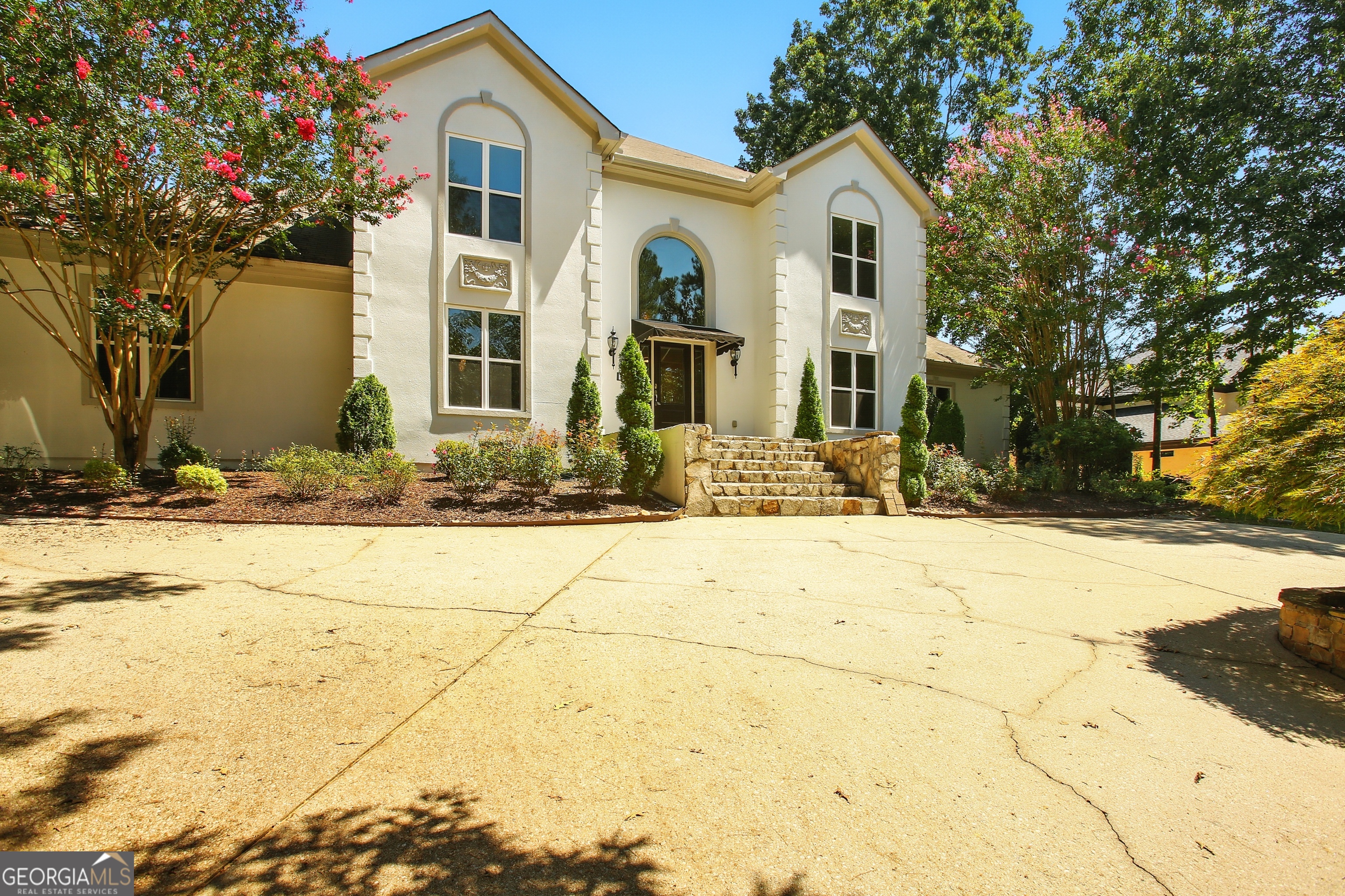 Indulge in timeless luxury at Lake Spivey. This fully renovated 4bedroom, 5bath estate offers over 4,200 square feet of grandeur on nearly two acres - surrounded by multimilliondollar estates and directly next to a brandnew $1.8M home. From the moment you step into the dramatic two story foyer with soaring 20 foot ceilings and a stunning chandelier, you feel the scale and sophistication of this home. The main level flows seamlessly into both formal and casual spaces - a richly detailed dining room, an elegant living room or office, and a sunlit great room with a custom builtin chic bar and fireplace. The gourmet kitchen is a true centerpiece, boasting new countertops, custom cabinetry, premium stainlesssteel appliances, and a breakfast area with builtin desk nook - perfectly blending beauty and function. The primary suite on the main level is a retreat unto itself, with vaulted ceilings and a newly renovated spalike bath featuring a freestanding tub, glass walkin shower, and sleek modern finishes. Upstairs, a second primary suite offers flexibility for guests or multigenerational living. Every detail has been considered - all new windows throughout, a brandnew septic system, new pool pump, rich flooring, plush carpeting, and crown molding. Step outside to your private oasis: an expansive deck overlooks the sparkling saltwater pool with a fully motorized cover, surrounded by a manicured lawn, circular driveway, and additional parking pad. This isn't just a home - it's a lifestyle. Surrounded by new and established milliondollar estates, this property is priced to offer unmatched value for the location, size, and updates.