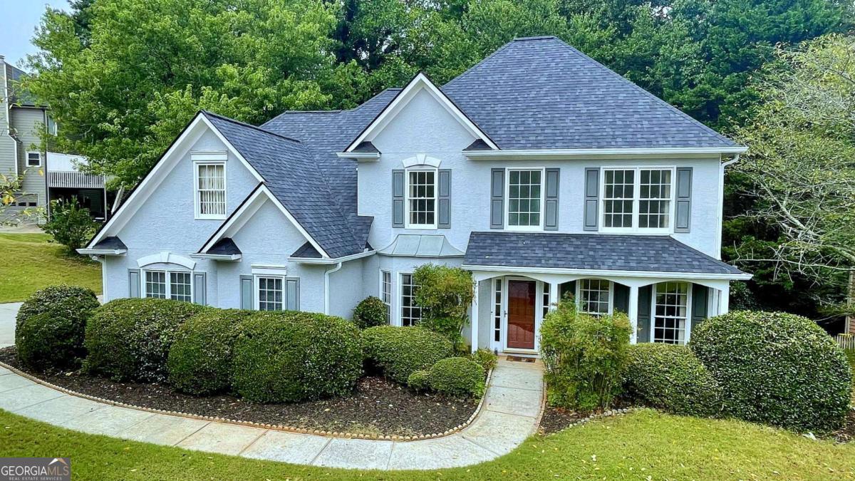 Rare opportunity to own this stately two-story home in the heart of Towne Lake, just minutes from Downtown Woodstock's dining, entertainment, shopping, outlet mall, Lake Allatoona, and Olde Mill Park! Nestled in the highly sought-after, established Deer Run North community, this home offers resort-style amenities including a pool, pickleball, tennis, basketball, clubhouse, and scenic walking trails. Located within top-rated school districts with easy access to I-575 for a smooth commute to Atlanta or the North Georgia mountains. Recent updates include a new roof, fresh interior paint, and an upgraded back deck. The home welcomes you with a grand two-story foyer, separate dining room with bay window, and a office/study also with a bay window. Hardwood floors span the main level, leading into a stunning two-story fireside family room with open railing view to the upstairs. The bright, open kitchen features white cabinetry, stainless steel appliances, and tile flooring. The main-level primary suite boasts a vaulted ceiling, walk-in closet, and a private bath with double vanity, garden tub, and glass-enclosed separate shower. A guest half bath, laundry room, large storage closet, and side-entry two-car garage complete the main level. Upstairs features a hardwood hallway, three spacious secondary bedrooms, a guest bathroom with double vanity and tub/shower combo, and a large walk-in attic space above the garage, perfect for storage or potential future expansion. Two additional closets offer even more storage. Enjoy outdoor living on the extended deck and patio overlooking a private, fenced backyard surrounded by mature trees, creating a serene retreat. This vibrant swim/tennis community with sidewalks throughout is the perfect place to call home, don't miss this one-of-a-kind opportunity; schedule your private showing today! Special Buyer Incentives Available! Take advantage of the Buy Before You Sell Program, enjoy a one-year temporary rate buydown (1% below market rate) OR a closing credit at no cost to the buyer, courtesy of Mark Baker/SWBC Mortgage.
