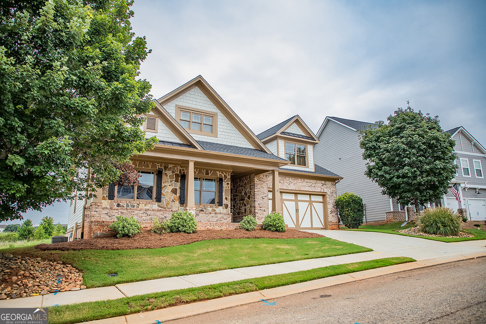 NEW PRICE REDUCTION ALONG WITH 14,000.00 IN SELLER INCENTIVE TO PAY FOR CLOSING COSTS OR BUY POINTS DOWN FOR A LOWER INTEREST RATE. Tucked away in the peaceful and desirable Madison Lakes community, this exquisite custom-built home blends modern design with exceptional craftsmanship. The exterior, featuring a striking mix of stone and sleek siding, immediately stands out, set against a backdrop of vibrant, low-maintenance landscaping. A charming front porch invites you to step inside and experience a space where elegance and comfort effortlessly meet. Once inside, you're welcomed by an open and airy layout, designed for both relaxation and entertaining. Tall ceilings and an abundance of windows flood the living spaces with natural light, highlighting the rich hardwood floors and soft, neutral tones throughout. The living room is cozy yet spacious, offering a perfect spot for gathering with loved ones, while the large windows bring the outdoors in, offering a view of the quaint, low-maintenance yard. The kitchen is well-appointed, featuring beautiful countertops, custom cabinetry, and stainless-steel appliances that make cooking a pleasure. The adjacent dining area, perfect for intimate meals, looks out over the small yet perfectly manicured backyard, where a charming patio area awaits, ideal for cozy outdoor dinners or peaceful relaxation. The master suite serves as a personal retreat, designed with comfort and style in mind. A spacious walk-in closet offers ample storage, while the en-suite bathroom provides a spa-like atmosphere with a deep soaking tub, an elegant glass-enclosed shower, and dual vanities finished with luxurious materials and attention to detail. Two additional well-appointed bedrooms offer comfortable living, with generous closet space and windows that fill the rooms with natural light. These rooms share a beautifully finished bathroom, designed with modern fixtures and a serene color palette. Upstairs includes a huge living area with bedrooms and 1 bath. The terrace level boasts a game room, bar, and 2 baths with 1 bedroom, and a media area. Though the backyard is compact, it's thoughtfully designed for ease of maintenance and enjoyment. Whether you're tending to a small garden, relaxing on the patio, or enjoying a quiet evening in a private space, it's the perfect outdoor oasis for low-key living. With its stylish interior, a location that offers both privacy and proximity to everything Madison has to offer, this home is a true gem, an ideal blend of comfort, convenience, and beauty. Please note need a 24-hour notice to show, tenant in place, please do not disturb. Can close within 30 days of contract acceptance. MOTIVATED SELLER
