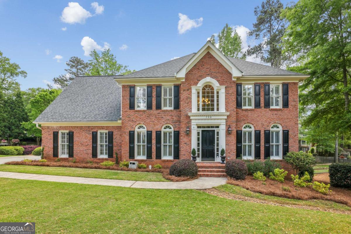 Nestled on a serene cul-de-sac in Johns Creek's desirable Doublegate subdivision, this magnificent 3-sided brick residence offers an unparalleled living experience. The prime location perfectly complements the home's meticulous design, featuring a flat driveway and over half an acre of beautifully landscaped, level grounds. Step inside to discover a bright and updated interior. Gleaming new and refinished hardwoods grace the main level, complemented by updated lighting in the two-story foyer, dining room, kitchen, bathrooms, and primary suite. The gourmet kitchen is a culinary dream, showcasing granite countertops, crisp white cabinetry, stainless steel KitchenAid appliances, and a premium Wolf 5-burner gas stovetop with a professional hood. The kitchen's sun-drenched dining area boasts a vaulted ceiling and three walls of windows, offering picturesque views of the park-like yard. From here, step out onto the expansive new deck with a charming Juliet balcony, ideal for entertaining or quiet relaxation. The open-concept kitchen seamlessly flows into a light-filled gathering room, complete with a cozy fireplace. Upstairs, the primary bedroom suite, with new lighting, provides a tranquil retreat. Its spa-like bath features new tile flooring, fixtures, and faucets. Two generously sized secondary bedrooms share a spacious bath with double sinks and a separate area for the shower/tub and water closet. A third secondary bedroom enjoys the privacy of its own bath and two walk-in closets. The light-filled terrace level, with a full wall of windows overlooking the lush backyard, offers versatile spaces perfect for a guest suite, home office, theater, billiards room, game room, or home gym. A large cedar closet provides ample storage. An additional separate room with an exterior door is perfect for yard equipment, a workshop, or extra storage. The terrace level walk-out leads to a patio, extending the outdoor entertaining options and overlooking the truly unique, flat, and exquisite yard. Further enhancements include exterior garage door with a quiet opener and an irrigation system in the front yard. A fenced backyard features a playset complete with slides and swings, offering delightful outdoor recreation. Radon treatment equipment (installed in 2020) completes this exceptional offering. This residence truly has it all!