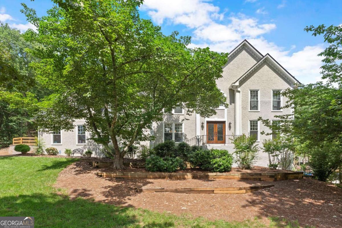 Stunning 5-Bedroom Home in Sought-After Lassiter High District. Welcome to your dream home in the heart of East Cobb's desirable swim/tennis community and the top-rated Lassiter High School district! Nestled on over an acre of private, wooded land, this beautifully maintained 5-bedroom, 4-bathroom residence offers over 4,000 sq ft of comfortable, elegant living space. Features You'll Love include, Spacious and Bright: Fresh interior paint and gleaming hardwood floors throughout the main level. A Chef's Kitchen which opens seamlessly to a cozy family room and a large dining room. A Primary Suite Retreat that is oversized with ample natural light and a beautiful ensuite bath. A Versatile Bonus Room with direct access to a sunny four-season sunroom and backyard. A Full Basement: that includes a mini kitchen, full bathroom, and endless potential for a guest suite, media room, or in-law apartment. Recent Upgrades include - Three new furnaces, New electrical panel, 4-year-old roof, Fenced level backyard perfect for pets, play, or entertaining just to name a few. Enjoy outdoor living with a sprawling deck, mature trees offering natural privacy, and room to garden, play, or relax. Plus, take advantage of the community's swim and tennis amenities just minutes away. This home has been maintained and loved so well it will be easy for the new owners to move right in and make it their own - You should be the lucky ones!
