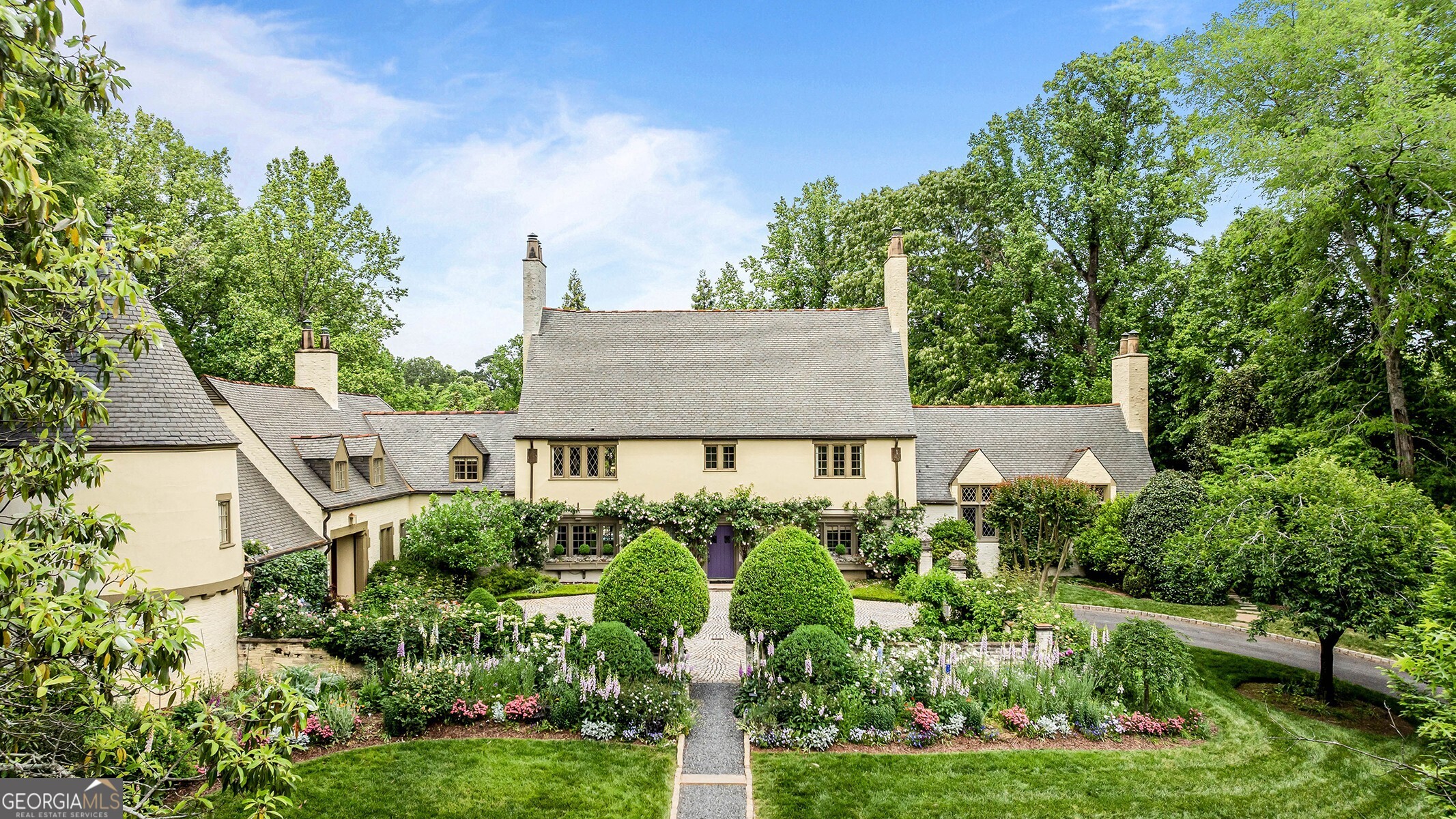 Welcome to a remarkable residence on over 1.5 acres in the prestigious gated community of 675 West Paces Ferry. This exquisite French Normandy home, originally built in 1934 and thoughtfully expanded by Harrison Design, combines timeless elegance with modern luxury. As you approach, you are greeted by beautifully landscaped gardens leading to a grand entry with striking black and white marble floors. The open floor plan is perfect for entertaining, featuring a formal fireside living room, a wood-paneled office, an elegant dining room, and a sunlit bar area. The gourmet kitchen boasts high-end appliances, a separate butler's pantry, and a dining area that opens to the inviting backyard. The expansive owner's suite offers luxurious ensuite amenities, while three additional bedrooms with ensuite bathrooms and an expanded playroom area in the turret complete the second level. The upper floor includes two more bedrooms and one full bathroom. The terrace level features a gym, wine cellar, and billiards room, perfect for relaxation and entertaining. Outside, enjoy several large porches overlooking lush gardens, a flat backyard oasis, and a sparkling pool and spa.  Located in the heart of Buckhead, this home provides easy access to fine dining, shopping, and both public and private schools. Experience the perfect blend of charm and sophistication in this extraordinary property.