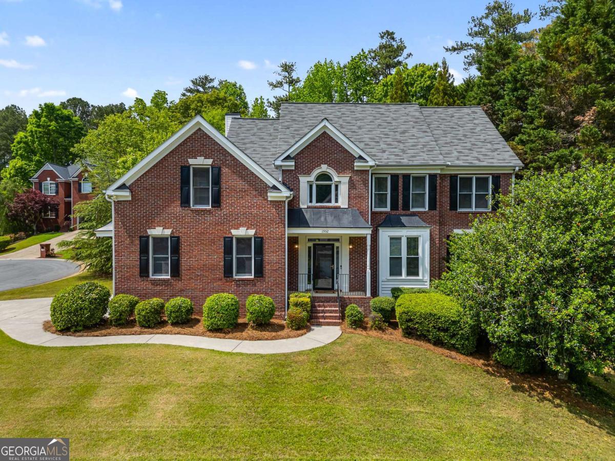 Located on a quiet cul-de-sac in Brentwood Park's sought-after swim and tennis community in East Cobb - this 5-bedroom, 3.5-bathroom home offers comfort, space, and timeless style. The two-story foyer leads to a welcoming sitting room and an elegant formal dining room, perfect for entertaining. The fireside living room flows seamlessly into a bright kitchen, complete with newly installed matte granite countertops, abundant cabinet storage for any kitchen appliance imaginable, a walk-in pantry, and a breakfast nook with views of the back yard. Just off the kitchen is a well-appointed laundry room with additional storage. Throughout the home, you'll find beautiful hardwood floors, updated light fixtures, and a 1 year old water heater. Head out onto the private screened-in porch to enjoy your morning coffee or unwind in the evening. The adjacent back deck overlooking the level backyard offers the ideal spot for outdoor summer grilling. Plus there's a newly renovated powder room, conveniently located away from the main living space. Upstairs, the oversized owner's suite features a tray ceiling and a spacious ensuite bathroom with dual vanities, new quartz countertops, a whirlpool garden tub, a separate shower, and generous double walk-in closets. Three additional bedrooms and a dual-entry bathroom with separate new quartz vanities complete the upper level. If that wasn't enough square footage, the finished basement provides flexible living space ideal for an in-law suite, featuring a den, a rustic bedroom and bath adorned with beautifully stained shiplap walls and ceilings. There's also ample unfinished space for storage, hobbies, or a workshop. Neighborhood amenities include a clubhouse, pool, tennis and pickleball courts, a playground and multi-sport court. Easy access to I-75, GA-120, Marietta Square, shopping, restaurants and cafes!