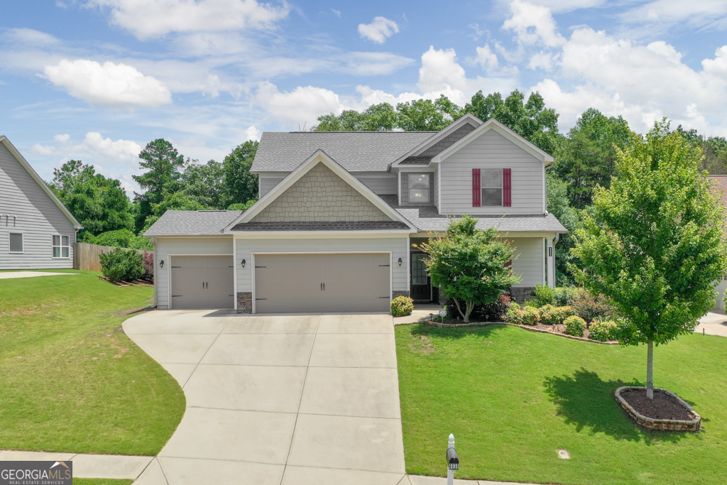 Pristine Master-on-Main on Beautifully Landscaped Lot! This meticulously maintained home is better than new with over $43k in upgrades! Upon entering the inviting front porch and two-story foyer, you'll discover durable LVP, fresh paint, crown molding and plenty of natural light. Open-concept family room with cozy wood-burning fireplace leads to lovely kitchen with granite countertops, stainless appliances, oversized breakfast bar and a charming dining area with custom bookshelves and built-in storage benches. Retreat to the spacious owner's suite on main with tray ceiling, dual vanities, beautiful tile shower, soaking tub and huge closet with built-ins. Upstairs offers a versatile loft/ media room, full bath with tile floors and granite counters, and three additional bedrooms with ample closet space. Step outside to the covered patio overlooking stunning, fenced backyard with extensive landscape and hardscape, creating a truly park-like setting with lush grass, vibrant flowers and mature trees. Storage is abundant with a three-car garage and large shed with ramp. Enjoy the Highland Gates community amenities, including swim, playground, and pavilion. Located near shopping and dining and just one mile from the impressive North Hall Community Center and Park, a 123-acre park with trails, ballfields, fitness center, pickleball and basketball courts, technology center, indoor track and more! Explore the beauty of Lake Lanier at Don Carter State Park, Laurel Park, or the Olympic Park- all within just a few miles. Don't miss this gem- schedule your tour today!