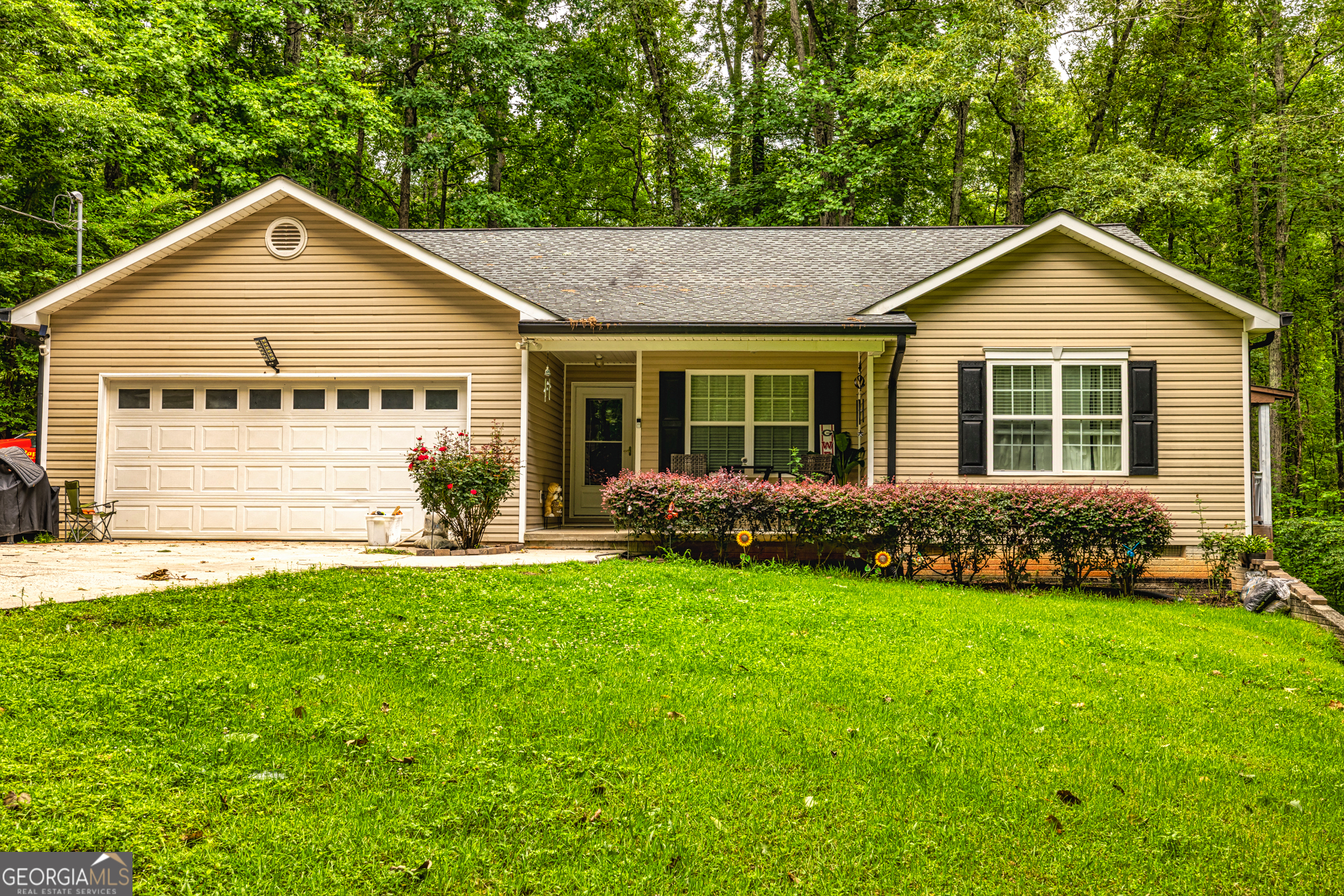 Tucked away on a private wooded lot, this well-maintained three-bedroom, two-bath home offers the perfect blend of comfort, convenience, and outdoor living. Step inside to find an open-concept floor plan with stylish LVP flooring throughout, a spacious living area, and a kitchen featuring solid surface countertops and stainless steel appliances-perfect for both everyday living and entertaining. The oversized wraparound back porch invites you to relax in your own peaceful retreat, complete with a covered section and a pool table that stays with the home-ideal for hosting friends or enjoying quiet evenings. Situated on a generous lot with plenty of privacy, this property also includes the option to purchase an additional 2-acre parcel, making it a rare find for those looking for even more space or future possibilities. Conveniently located close to shopping and just minutes from I-85, you'll enjoy easy access while still feeling tucked away from it all. A perfect combination of nature, comfort, and accessibility-don't miss this one!