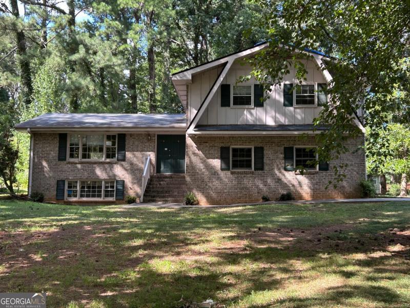Fixer-Upper Opportunity! Spacious 3-bedroom, 2-bath home with a 2-car attached garage. This inviting property features a large wooded front and backyard, providing privacy and a natural setting. Conveniently located with easy access to I-20 and I-285, it's perfect for commuting and enjoying everything the area has to offer. With some TLC and personal touches, this home has the potential to shine. Don't miss out-bring your vision and make it yours today!