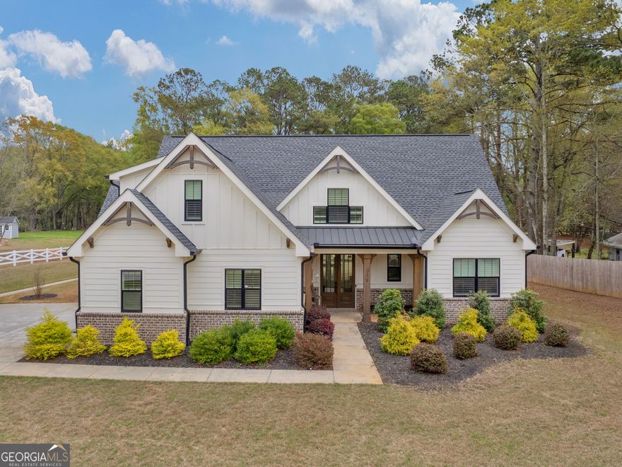 Welcome to this beautifully designed 4-bedroom, 3.5-bathroom Craftsman-style home nestled on over 2 acres of land. From the moment you step inside, you're greeted by the warmth of beamed ceilings and the timeless character that defines this home. The heart of the home is the spacious open-concept kitchen and living area-perfect for both everyday living and entertaining. The chef's kitchen features a large center island with ample seating, custom cabinetry, and modern appliances. Flowing seamlessly into the living room, you'll find a stunning floor-to-ceiling stone fireplace that anchors the space and invites cozy gatherings year-round. The generous layout offers four well-appointed bedrooms, including a primary en suite with a soaking tub. With 3.5 bathrooms in total, there's plenty of room for family and guests. Step outside and enjoy the peacefulness on your screened porch -ideal for outdoor entertaining or simply enjoying nature's beauty. Whether you're looking for rustic charm or refined comfort, this home offers the best of both worlds in a picturesque setting. Ask how you can receive up to $1500 credit by using one of our preferred lenders.