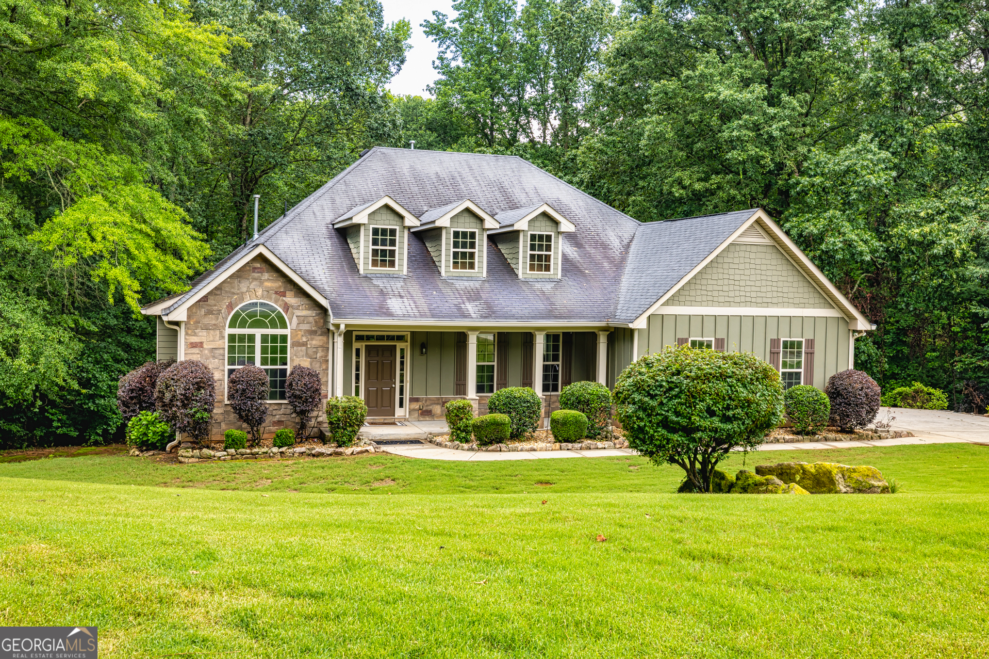 Discover this stunning Craftsman-style home for sale in the coveted Barrington Farms neighborhood in beautiful Sharpsburg, offering quick access to Newnan and Peachtree City but without the HOA restrictions. This spacious residence boasts high ceilings and gleaming hardwood floors throughout, creating an elegant and inviting atmosphere. The split bedroom plan features a luxurious primary bedroom on the main floor with a recently re-tiled en-suite bathroom showcasing a new 2024 shower. Two large additional newly-carpeted bedrooms on the opposite side of the home provide ample privacy, while the shared main-floor bathroom has also been recently re-tiled. An upstairs bedroom (also newly carpeted) with a full bathroom serves as an ideal teen suite or craft room, bringing the total to 3.5 bathrooms. The expansive, unfinished basement, stubbed for plumbing, offers abundant storage or future customization potential. Enjoy outdoor living on the spacious deck outside the family room, resurfaced in 2024, perfect for entertaining on this nearly 4-acre wooded lot. Modern upgrades include less-than-2-year-old HVAC units and newer septic system pump and drain fields, ensuring peace of mind. Located in the top-rated Northgate High School district, this Sharpsburg real estate gem combines Craftsman charm with modern renovations. Schedule your tour today to experience this move-in-ready home in Barrington Farms!