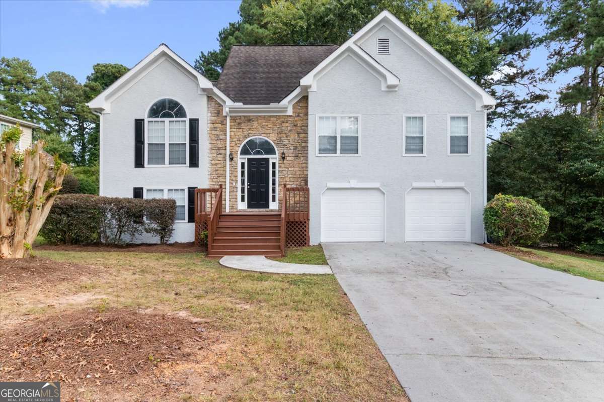 Welcome to Loganville and the highly sought-after Archer School District! This beautiful 4-bedroom, 3-bath split-level home offers all the space your family needs. The upper level features an open floor plan with a family and dining room combination, an eat-in kitchen with stainless steel appliances, and access to a spacious deck overlooking a flat backyard-perfect for entertaining. The master suite boasts double vanities, a separate shower and tub, and a walk-in closet, along with two additional bedrooms and a full bath on the same level. The lower level includes a private bedroom with a full bath-ideal for an in-law or teen suite-plus an additional family/media/game room for endless possibilities. Priced to sell, this home is move-in ready and located in one of the area's top school districts. Don't miss your chance-schedule your showing today!