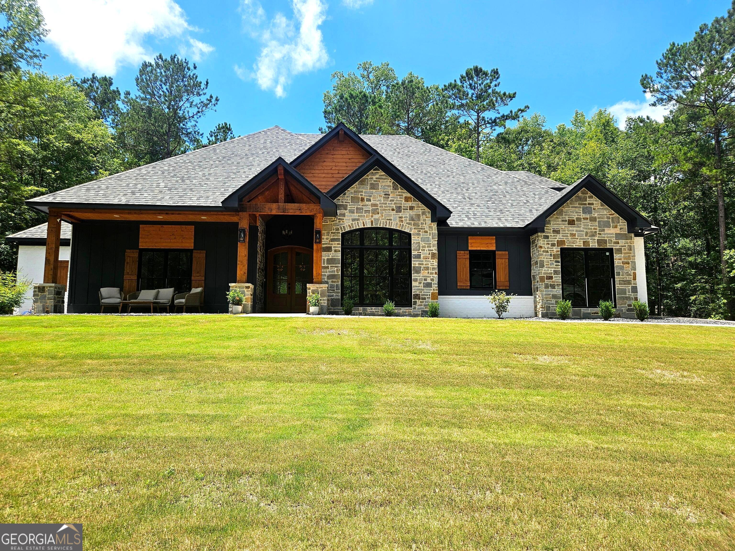 THIS GORGEOUS LUXURY THOUGHTFULLY DESIGNED CRAFTSMAN 5 BED, 4 & 1/2 BATH HOME SITS ON 2.07 ACRES, IN A PEACEFUL AND WOODED LOT! UNBEATABLE HIGH-END FEATURES FROM THE FLOOR TO THE CEILING AND ALL EXTERIOR DESIGNS BOAST CRAFTSMANSHIP. MASTER SUITE AND 3 MORE GOOD SIZED BEDROOMS WITH 2 FULL BATH AND POWDER ROOM ON MAIN AND ONE HUGE BEDROOM WITH FULL BATH UPSTAIRS, OPEN FLOOR PLAN WITH VAULT CEILINGS ADDED WITH SOLID CEDAR BEAMS, EUROPEAN OAK HARDWOOD FLOORS THROUGHOUT THE ENTIRE HOUSE, FAMILY ROOM WITH NATURAL STONE STUCCO FIREPLACE W/CEDAR EXPOSED BEAM, GOURMET KITCHEN OFFERS QUARTZ COUNTERS, BEAUTIFUL BACKSPLASH, MIX OF STAINED & PAINTED HARDWOOD CABINETRY, EXTENDED CENTER ISLAND WITH QUARTZ TOP AND FARMHOUSE SINK, UPGRADED STAINLESS STEEL APPLIANCES, OVERSIZED BUILT-IN REFRIGERATOR, BUILT-IN WINE COOLER, POT FILLER, GAS STOVE, TWO SEPARATE OVENS, COVERED FRONT PORCH, COVERED HUGE OUTDOOR LIVING AREA WITH FIREPLACE, FRIG, BUILT-IN GRILL W/VENTHOOD AND A SINK PERFECT FOR ANY GATHERING THROUGHOUT THE YEAR. LOOK NO MORE FOR BEAUTY, COMFORT, PRIVACY, SERENITY, AND YOUR FOREVER HOME THAT WILL MAKE YOU PROUD TIMELESSLY. 2024 PROPERTY TAX IS BASED ON THE RAW LAND.