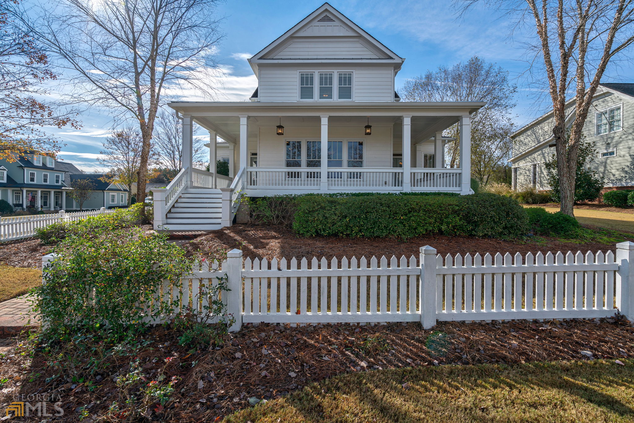 Don't miss this fabulous 4 bed, 3 bath home just listed in OCONEE COUNTY inside the gates of THE GEORGIA CLUB! 1610 Oconee Springs Boulevard is located on the corner of Oconee Springs Boulevard and Greenleffe Drive perched overlooking the Oconee Springs post office. The wrap-around porch of this home is the perfect place to enjoy a beautiful day or an evening cocktail. From the lanterned porch, guests are welcomed into an entry foyer streaming with natural light which highlights the stunning heart of pine floors that extend throughout the entire first floor of this wonderful home. To the left of the entry is a first-floor bedroom with private access to the additional first-floor bathroom. This room is perfect for a first-floor office or welcoming overnight guests. To the right of the entry foyer are the public spaces of this home including a spacious living room with a fireplace with gas logs flanked by custom-built bookcases, a large dining room with fantastic views that easily seats 12, and a well-designed kitchen with white cabinets, stone tops and backsplash, and stainless steel appliances. The dining room has easy backdoor access to the well-sized, rear paver patio and is connected by a convenient covered walkway to the detached oversized garage. The owner's suite of this home spans the entire back half of this home with a spacious bedroom featuring beautiful trim, heart of pine floors, and plantation shutters that filter beautiful natural light into the room; a well-designed closet with a custom closet system that organizes the space; and a spa-like tiled bathroom with white, comfort height "his" and "her" vanities with stop tops, a large shower with bench seating, multiple shower heads, a frameless glass shower enclosure, and a separate water closet. The upstairs of 1610 Oconee Springs Boulevard offers a loft area perfect for a home office station or lounging space, two additional large bedrooms with great closet space, plantation shutters, and access to a jack and jill bath with a tiled shower with a frameless shower enclosure. The private yard of this home is filled with mature landscaping offering beautiful green space and plenty of privacy. This home is zoned for the award-winning North Oconee Schools, Dove Creek Elementary School, Malcolm Bridge Middle School, and North Oconee High School. The Georgia Club is a gated community offering a lifestyle found nowhere else in the Athens area with a private golf, swim, tennis club complete with 27 holes of championship golf, on-site dining six days a week at the full-service clubhouse, 8 lighted tennis courts with pro services, an aquatic center with two pools, a fitness center offering cardio and weight training equipment in addition to classes, Pickleball, walking trails, and so much more.