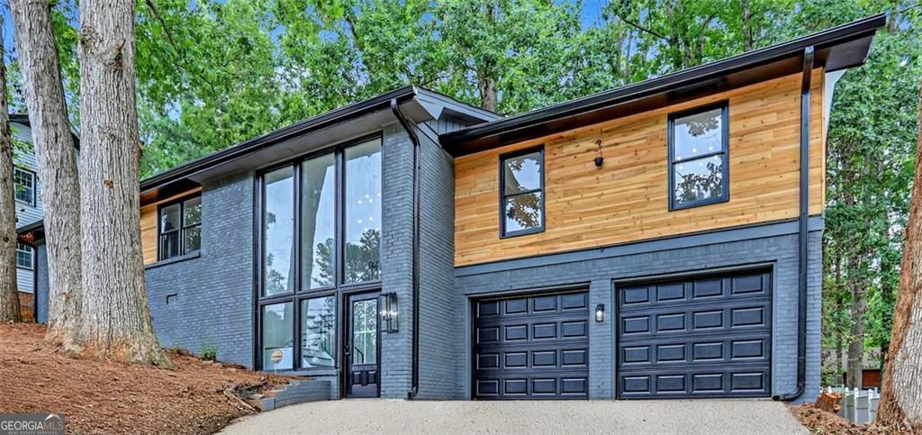 Stunning Modern Renovation with Floor-to-Ceiling Windows & Designer Finishes Welcome to this beautifully updated 4-bedroom, 2-bath home, on a quiet cul-de-sac street where modern elegance and thoughtful upgrades meet comfort and functionality. As you enter through the light-filled foyer featuring full-length floor-to-ceiling windows, you'll ascend the open staircase to a bright and airy main living area with brand-new wood flooring throughout. The open-concept layout centers around a gourmet kitchen designed for both style and practicality. Enjoy sleek quartz countertops, a coordinating backsplash, an oversized island perfect for gathering, white cabinetry with ample storage, and brand-new stainless steel appliances. The spacious dining area showcases custom wall trim and flows seamlessly into the inviting living room, which features a full accent wall of elegant trim work. Step out from the kitchen and dining area into the large glass-enclosed sunroom or onto the rear deck-both overlooking the private, fenced backyard-ideal for entertaining or simply relaxing. Retreat to the luxurious primary suite with a spa-inspired quartz-tiled shower featuring dual shower heads, dual vanities, and modern finishes. The secondary full bath has also been fully renovated with a quartz-tiled shower, stylish cabinetry, and an on-trend modern sink. Additional highlights include: Two-car garage with backyard access and extra storage space New roof New electric water heater New electrical panel, updated plumbing, new sewer line & water line HVAC system approximately 3 years old All new flooring, cabinetry, fixtures, and bathrooms throughout This home is truly move-in ready and offers timeless style with peace of mind thanks to all the major system upgrades.