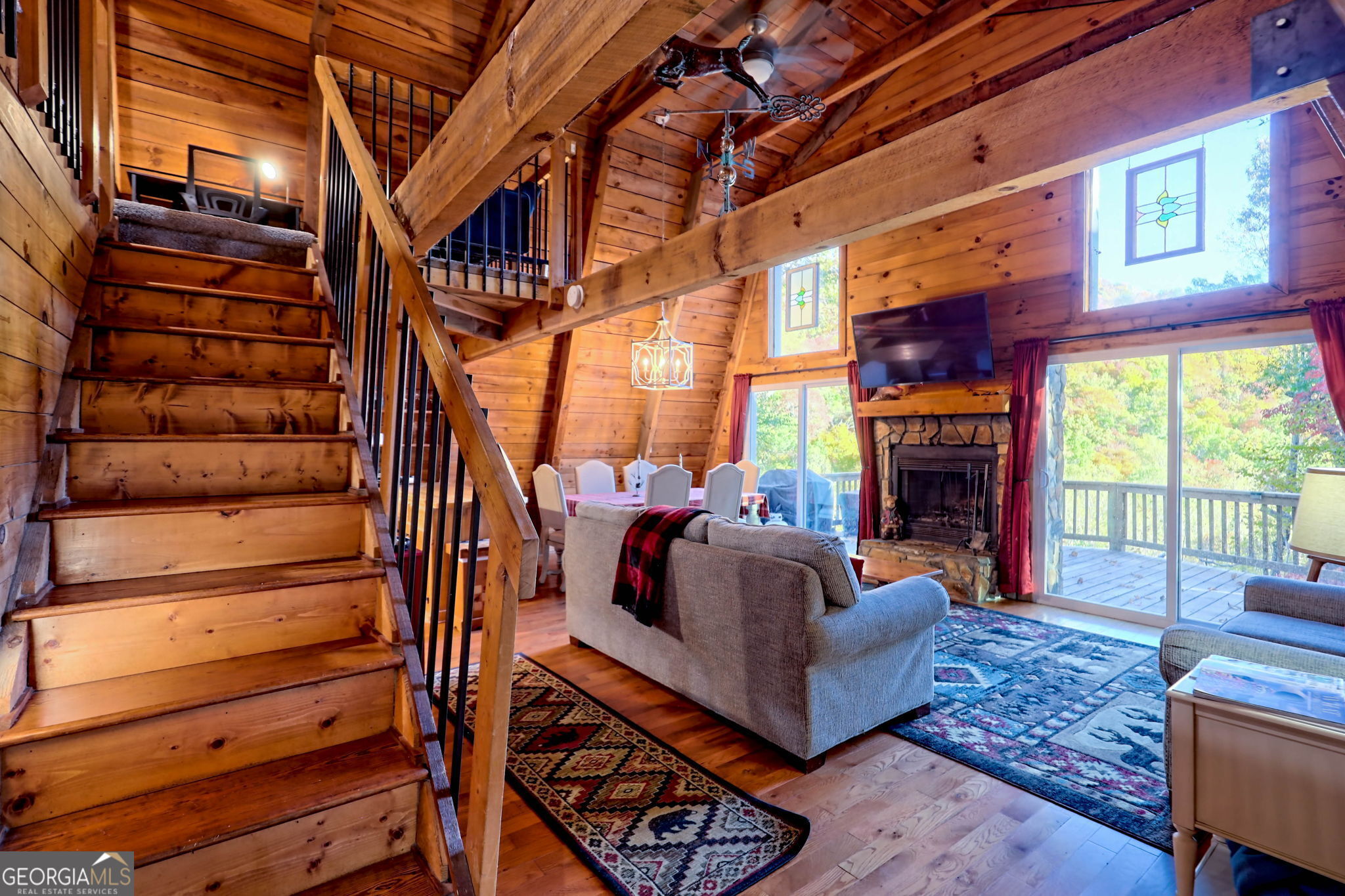 Bring your clients and don't miss this charming rustic cabin in Sky Valley. It is absolutely perfect and versatile, either for full time living, a second home or a profitable vacation rental. The home features three bedrooms and two full baths with a sought-after ensuite master conveniently located on the main level. Two additional bedrooms upstairs share the additional bath. The expansive windows in the main living area provide an abundance of natural light and display beautiful mountain views of the surrounding area with easy access to the expansive deck for your morning coffee or a glass of wine in the evenings. The open floor plan boasts hard wood floors with a beautiful wood burning stone fireplace. With a total of 1920 sq. feet, this spacious home has plenty of room for your family & friends to gather and create decades of memories. Another bonus is it is being offered fully furnished so all you need is your toothbrush & your jammies! Sky Valley offers the outdoor enthusiast numerous hiking trails with picturesque waterfalls, trout fishing, zip lines, skiing, tubing and even a roller coaster and gem mining for the kids! And let's not forget that its close proximity to Highlands NC gives you access to its splendid shops and restaurants without the higher Highlands Real Estate prices.