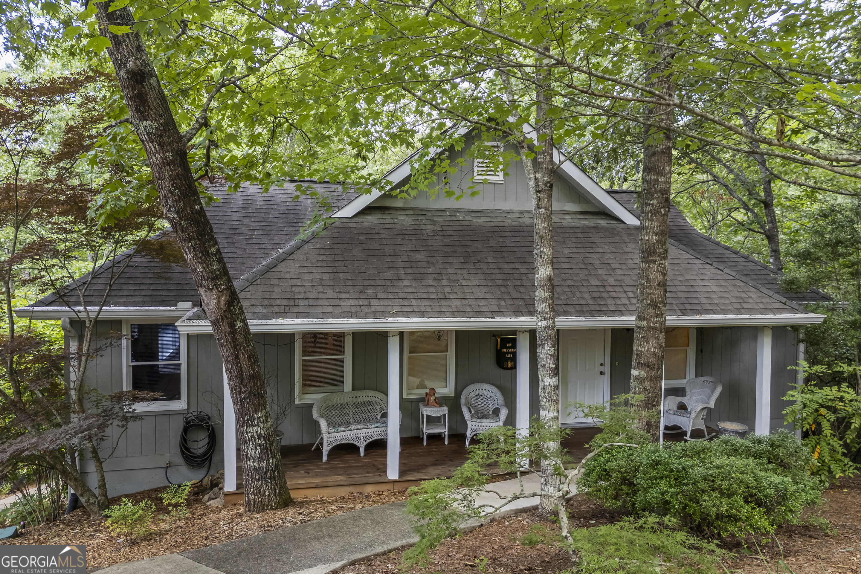 Nestled on the 9th fairway in the charming German town of Helen, GA, this VERY meticulously maintained home offers breathtaking views, convenience of one-level living on the main AND comes furnished! This home really does have it all, boasting 3 bedrooms and 3.5 baths, each with its own ensuite, this home provides ample space and privacy. The living room is spacious with its cathedral ceiling and is open to the kitchen and dining area. The kitchen offers ample storage with lots of cabinets and smart shelving. Enjoy the scenery from your screened-in porches or entertain on the open deck while grilling. The master suite also opens to the sun deck! Downstairs there is another large family room/game room with a kitchenette and the other 2 bedrooms with a private full bath each. There is also a workshop providing extra space for tools and equipment. Never rented publicly, this home has served as a cherished second home but qualifies for short-term rentals, presenting a unique opportunity for a double rental with separate entrances for the main level and lower level. The current owners loved the beautiful trees but with a little clearing, it would open up the view to the 9th fairway. This is a remarkable investment opportunity in Innsbruck that combines luxury and practicality, and it's move in ready!! You will not find a more taken care of home, so call to book your appointment today to own a piece of Helen's beautiful Innsbruck!