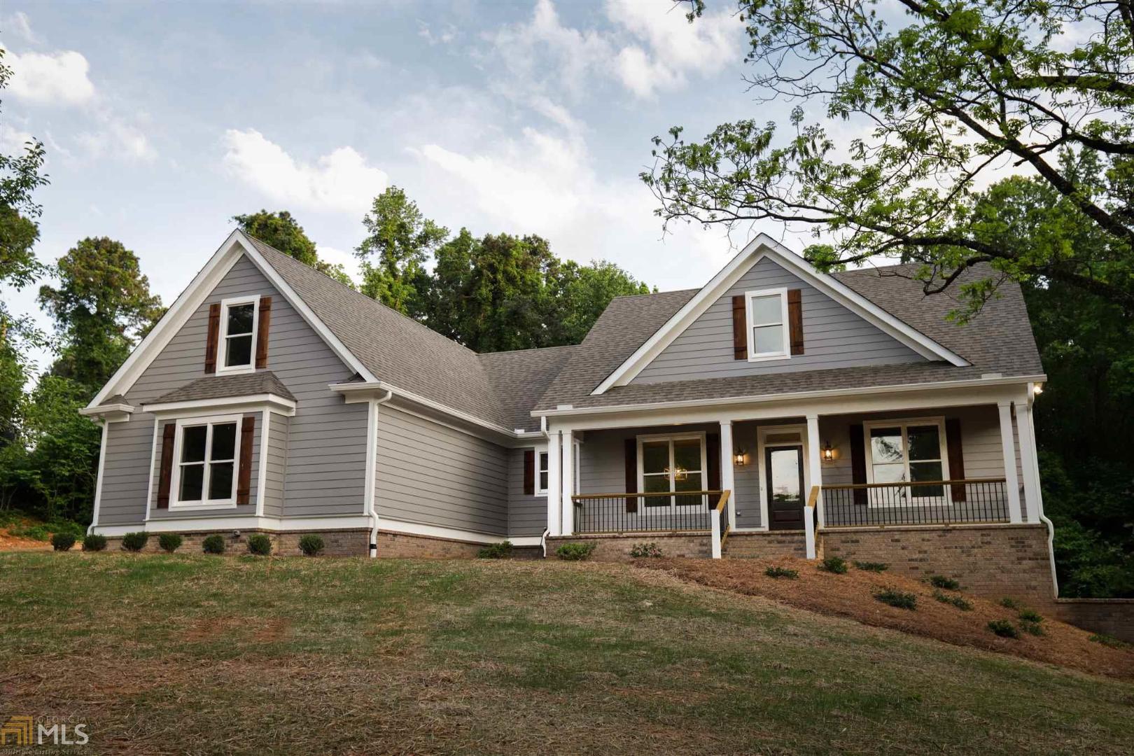 Beautiful home on private lot! This floor plan is ideal for entertaining and daily living. 4 bedrooms, 3 full bathroom home with screened in porch on an unfinished basement on 2.44 acres!! Close to Madison and Monroe yet still quiet and private. Just minutes to the new Hard Labor Creek Reservoir. Features to include Hardie siding, brick water table and foundation wrap, spray foam insulation,oak hardwood floors, shiplap, reclaimed wood and SO many custom features! You WILL NOT find another one like this on the market!! Builder to pay $5,000 towards closing if buyer uses Eva Aycock with Acopia Home Loans. Square footage and some plan features subject to change, contact listing agent for more information.