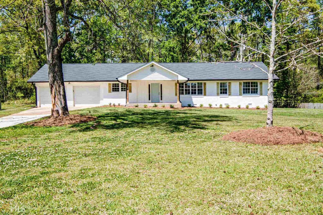 Multiple Offers on this beautiful home! Just what you’re looking for!! *Recently renovated* 3 bed/2 bath ranch style home with an inground pool, fenced back yard on a flat lot! New driveway, new roof, new 6" black gutters and new landscaping. Notice the beautifully painted brick exterior with custom built shutters and the extra large covered front porch! As you walk into the front door you are met with an open floor plan that is full of natural light. So many new features including black accent fixtures! painted inside and outside. New LVP flooring throughout the main living space, all new carpet in the bedrooms and new tile in the bathrooms. New LED lighting includes halo ceiling lighting and light fixtures throughout. Home features a beautiful kitchen with all new shaker style cabinets with black pulls, new customized butcher block countertops, deep sink with matte black faucet, new white subway tiled backsplash and new black stainless steel appliances including the double door refrigerator. Shiplap accent walls in kitchen, dining room, living room, and bathroom. Updated bathrooms include Bright white bathroom with matte black accents and beautiful barn door. Two car garage with built in storage shelves/work station, completely finished with wood from the walls to the ceiling and has a door that opens up to the backyard and pool area. Summer is almost here and this home features the perfect backyard paradise for it! Experience days and nights in your private fenced in backyard. Walk out onto your huge covered gabled back porch looking out to the in-ground pool and covered daybed swing. Perfect place to sit and relax to read a book or watch the kids swim. Backyard also has a large pool house/building/workshop with electricity that is great for storage or can be tailored to your specific needs or wants... make It a cool pool house with an indoor / outdoor entertainment area all with a brand new roof. There is also a small pen with a gate. This home is in the perfect location. Close to Downtown Newnan, Ashley Park and the grocery stores for all your shopping needs and restaurants.