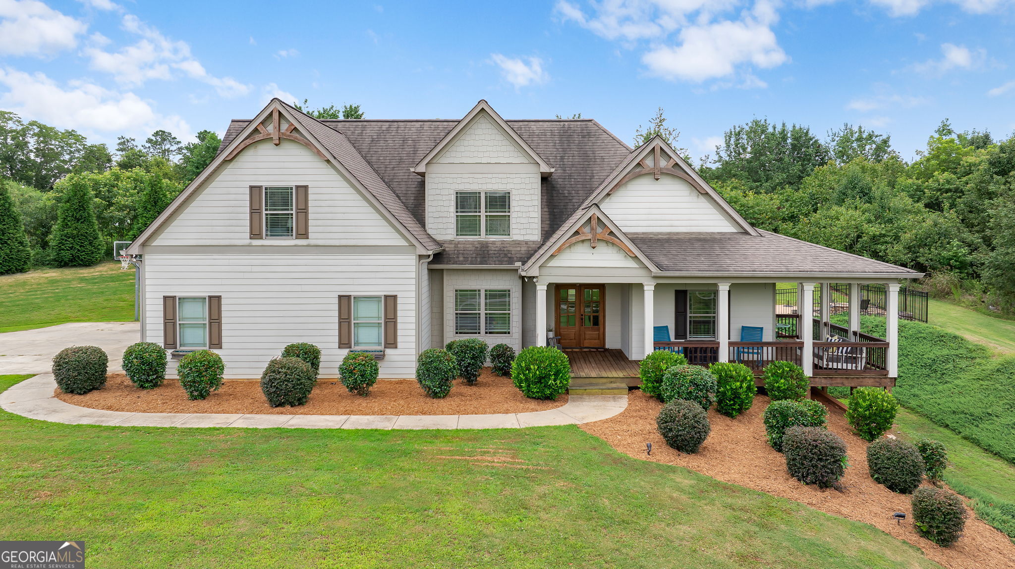 Welcome to 4227 Harold Whelchel Rd a picture-perfect Charming Country Retreat on 1.37 Acres - Just Minutes from Lake Lanier! This beautifully updated 4-bedroom, 3.5-bath home is nestled in the desirable North Hall area right off Mt. Vernon Rd. You've probably had your eye on this home for years, & now for the first time, it can be yours! Step inside to a bright, open layout featuring true hardwood flooring basically throughout the main level, & charming farmhouse touches throughout including shiplap accents in the dining room & a cozy, welcoming feel in every space! The large living room with fireplace just sets the tone for this unique property. The updated kitchen boasts white cabinetry, granite counters, stainless steel appliances, & a large island with custom butcher block countertop, perfect for entertaining & everyday living. The oversized primary suite is a true retreat with walk-in closets & a beautifully renovated en-suite bath. With three additional bedrooms & two fully updated bathrooms upstairs, complete with tiled showers & flooring, the space is incredible & updated exquisitely throughout the home! Step outside & fall in love with the screened-in back porch, beautiful gunite swimming pool with a tranquil waterfall feature, & a professionally crafted fire pit just to the right of the pool. All this in the privacy of your own backyard! On the large covered front porch, overlooking your front yard and pastureland, your views are top notch perfect for morning coffee or sunset gatherings. Whether from the front or the backyard, it feels like your own private retreat! The full unfinished basement is just another opportunity and offers room to grow, while the property itself provides tons of privacy, beautiful scenery, & endless possibilities. Come check it out today, because it won't last long! Please inquire about the adjoining 1.37 acre lot, sold separately, and seen in the pictures for additional