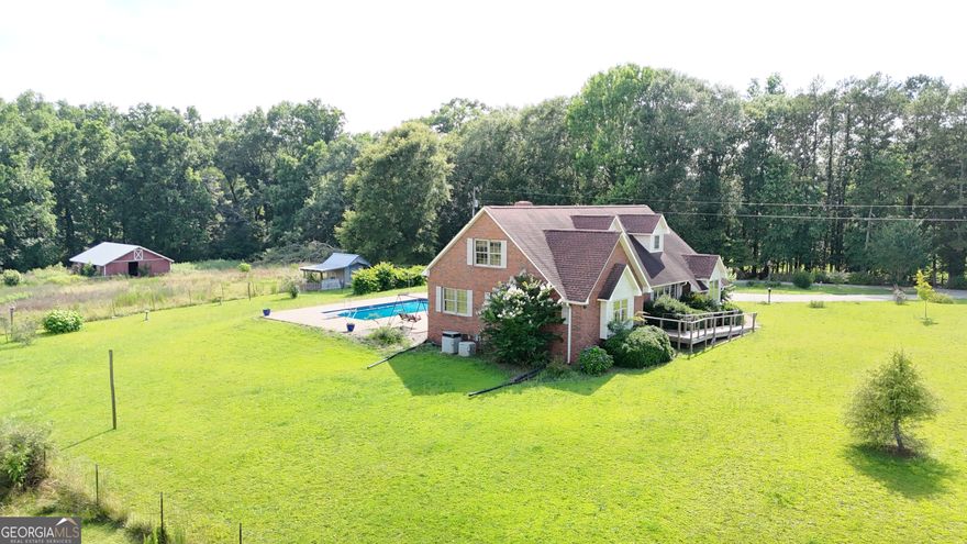 Charming estate, perfectly nestled on 10 acres across from Lake Hartwell. This property boasts the privacy of country living with the conveniences of shopping, dining, and so much more! Whether you are seeking the recreational opportunities that can be explored on Hartwell Lake or simply looking for the perfect place to raise your family, this property checks all of the boxes. The well cared for brick   home features 4 bedrooms, 2 full baths, a half bath,  custom cabinetry, hardwood flooring throughout, and upgraded trim.  In addition to the home, there are 2 garages and a barn. Did I mention there's also an unground pool? It simply doesn't get much better than this! You won't want to miss out of this beauty! The joining 30 acres can also be purchased as well.