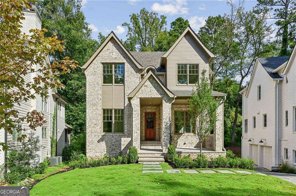 One of two stunning new homes in the heart of Peachtree Hills. Meticulously crafted by Rob Garrison Builders the 4-sides brick 3-story home sits perfectly on a quiet street. The curb appeal is designed to be both classic and striking Co and it delivers. Walking distance to Peachtree Battle shops and restaurants, the Duck Pond Park and Peachtree Hills Park, the 6-bedroom home combines generous light-filled spaces, thoughtful architecture and flow, carefully curated finishes, and a quality and attention to detail. Set on a big lot with a private, level backyard, there is plenty of privacy and room to run. Striking front windows and entrance create a bold statement and invite the light in. The home has both grand and cozy spaces and rooms flow seamlessly throughout the three floors. Main Level: Big covered front slate porch, entry foyer, formal dining room. Stunning chefCOs kitchen w/10ft island, Thermador, and separate sun filled breakfast room. Scullery/butler pantry with beverage fridge and prep sink plus custom shelved walk-in pantry. Huge family room with beamed ceilings and custom limestone fireplace and wall of glass that invites you out to the large rear covered porch with masonry fireplace. Separate study or guest wing on the main level includes a full bath. Upper Level: Spacious primary suite with trey ceilings, a stunning owner's bath and huge dressing area. The wide and bright upper hall leads to three large secondary bedrooms with big closets and two custom fitted baths and a cozy reading or homework nook. The carefully considered laundry layout maximizes storage, light and counter space. Terrace Level: Oversized 2-car drive-under garage with workshop and additional bike/stroller storage space. Mudroom entry with coat closet. 6th private bedroom suite. Giant daylight recreation room with wet bar. Easy wide driveway. Flat backyard with room to spread out and go!