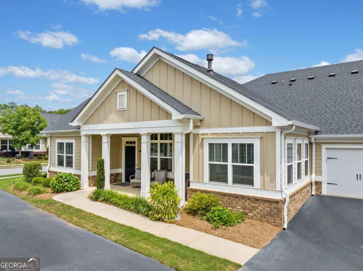 Ready to downsize ??You will love this ranch condo in popular Orchards of Cherokee Station. This home boasts hardwoods in the great room, dining room and kitchen. The great room a gas log fireplace, surround sound system and is open to the dining area. Lots of granite counterspace, luxurious wood cabinets with pull out shelving and black ss appliances make this a wonderful & workable kitchen for the chef in the family. There is a gas stovetop and a wall oven. There is a dedicated office with french doors on the main between the two bedrooms. The spacious owners suite has trey ceilings and is carpeted. Owner's bath has walk in shower and double vanities. The closet space is awesome in this property. The secondary bedroom has a trey ceiling and is carpeted. Laundry room on the main has a storage closet. Permanent stairs to the attic from the garage lead to a finished room with heat and air. It could be used as an office or craft room or storage. You won't find a friendlier community with a huge clubhouse that houses an exercise room and showers for the salt water pool. This is an active adult community and is in walking distance to the library, shopping and all you need to live independently. Social activities round make this a great place to live. HOA fee includes landscaping, pool, trash service, the roof and exterior maintenance. Orchards communities have wonderful homes and this one is only 7 yrs old. Hurry to see this one.